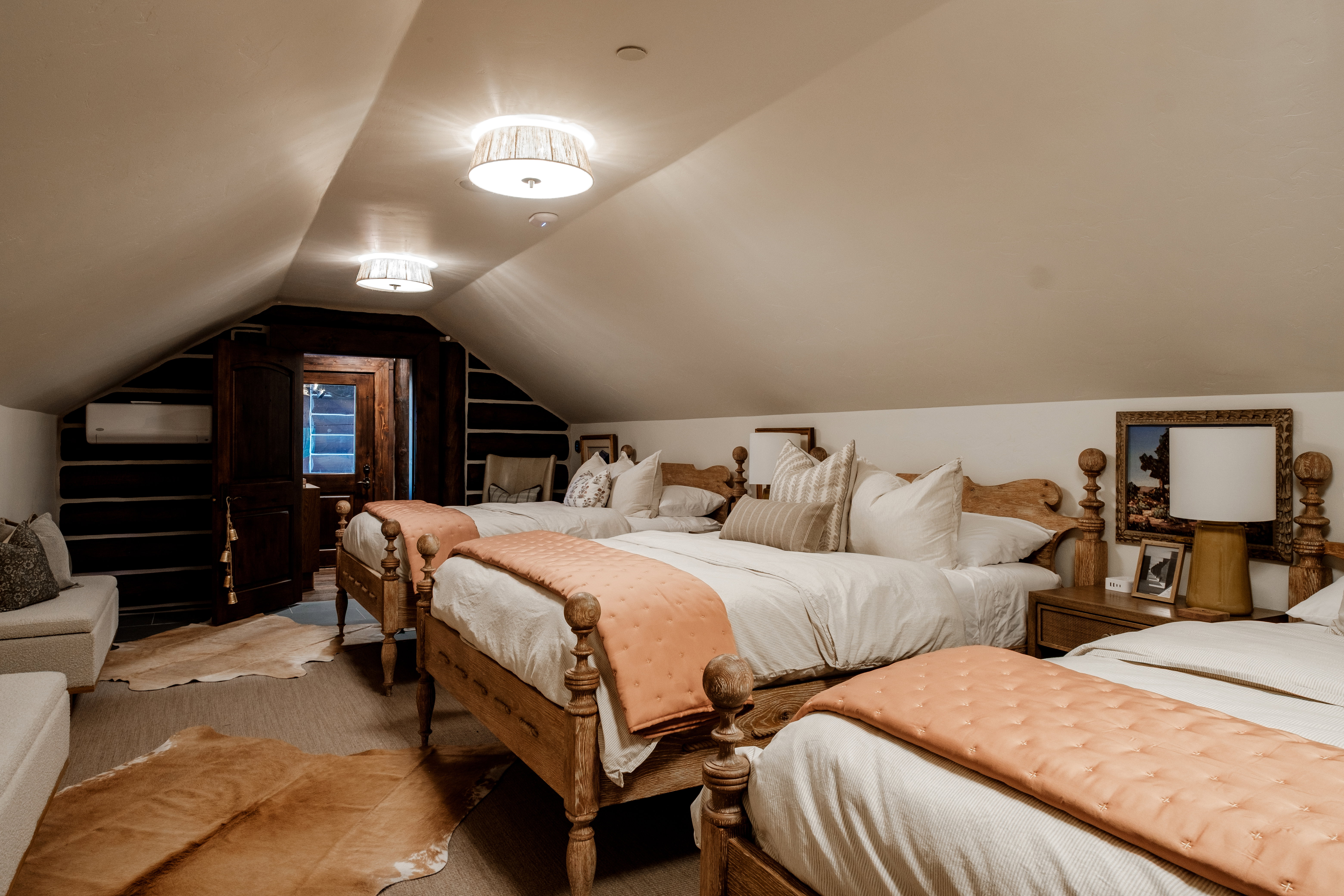 Attic space featuring sloped ceilings and exposed wood beams
