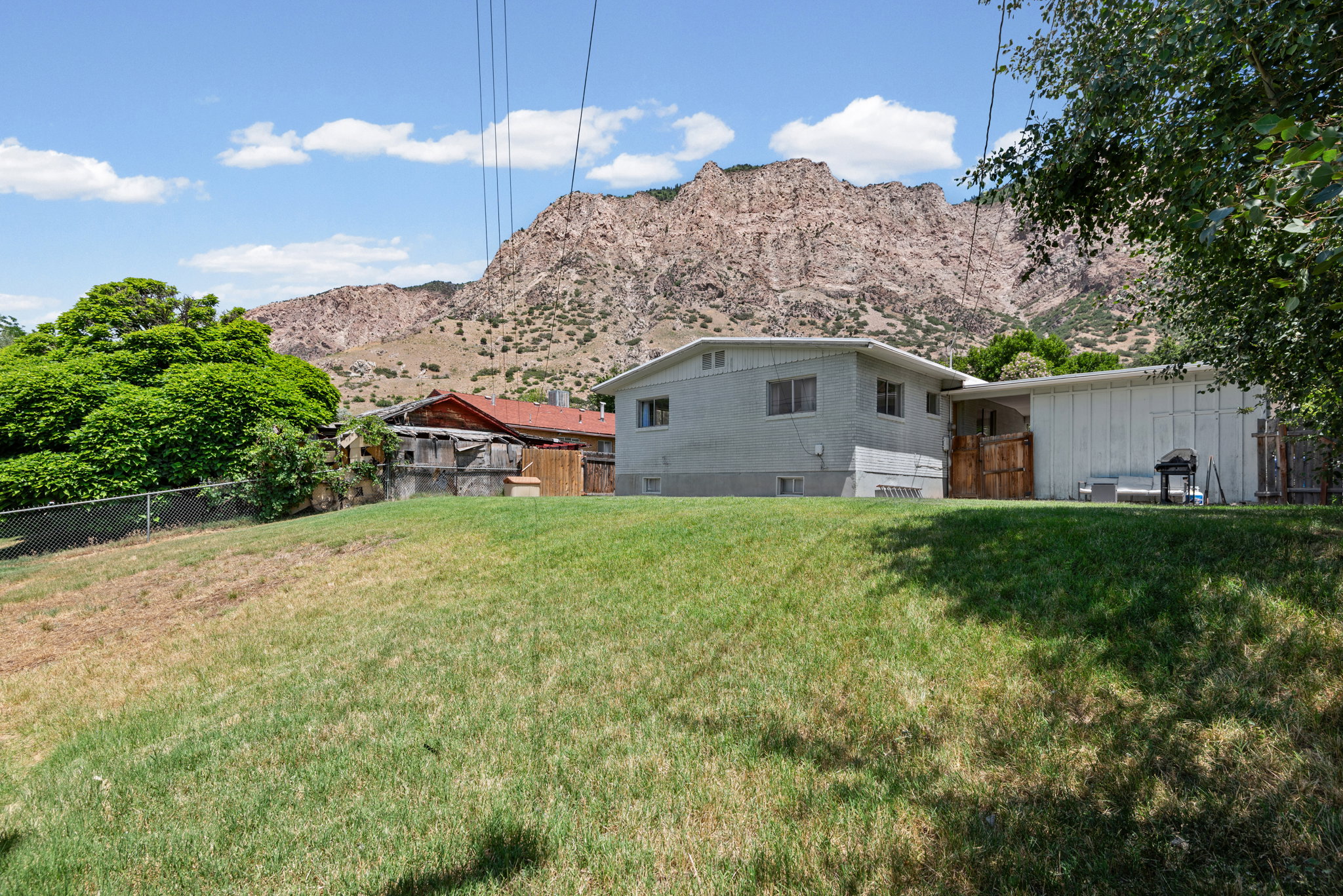 Expansive grassy yard with mountain scenery