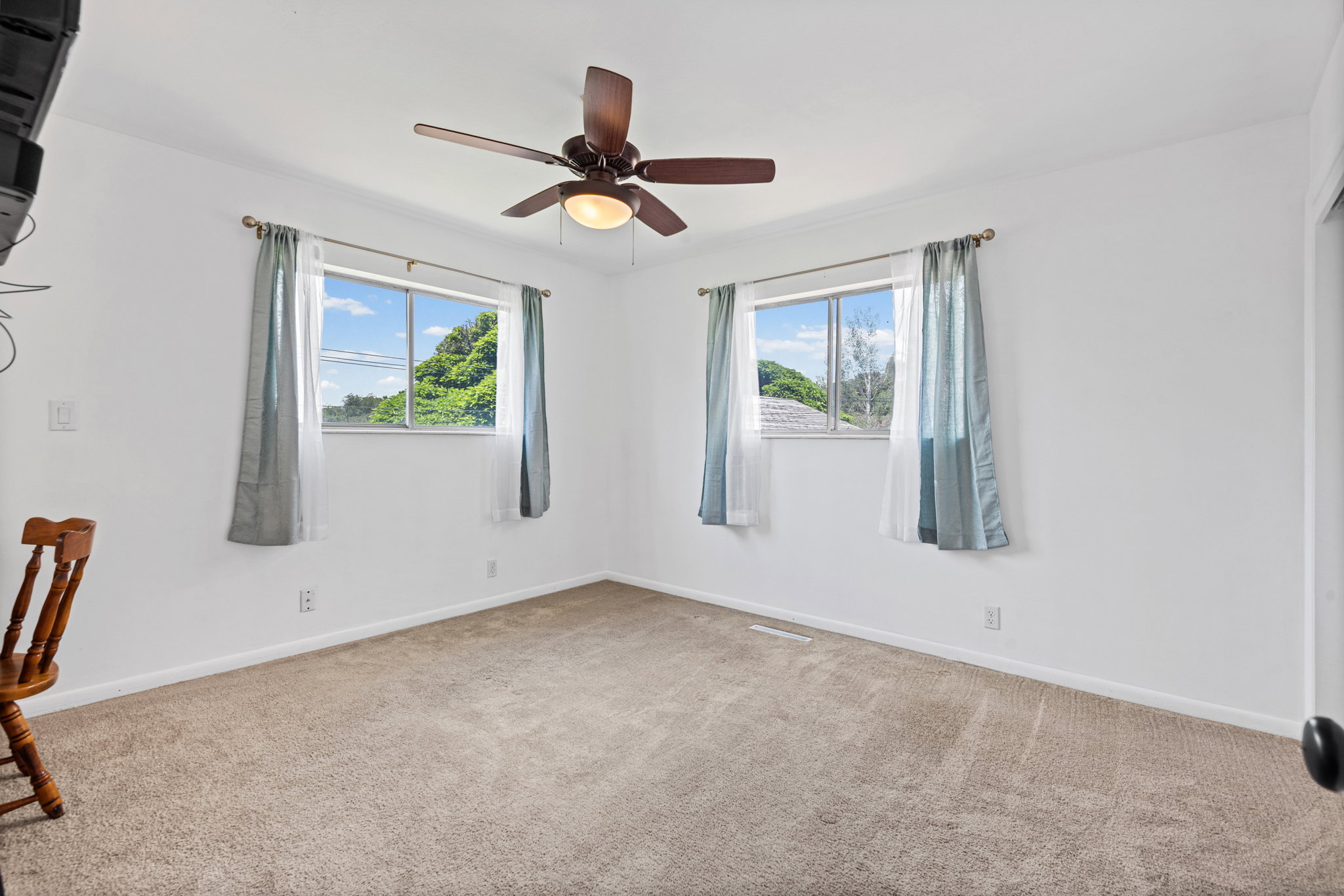 Neutral-toned carpeting and white walls create a versatile interior