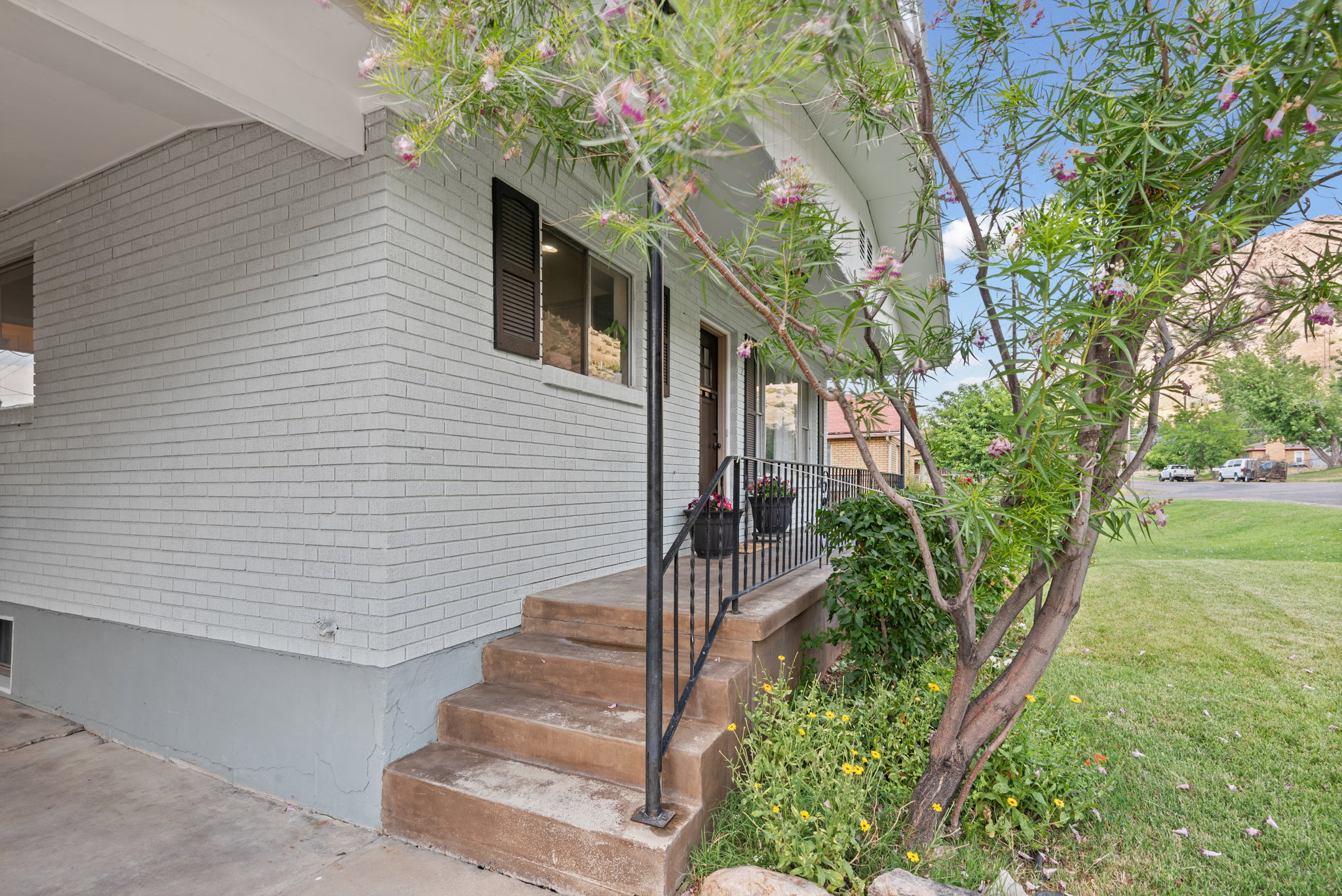 Brick exterior with a covered entryway and concrete steps