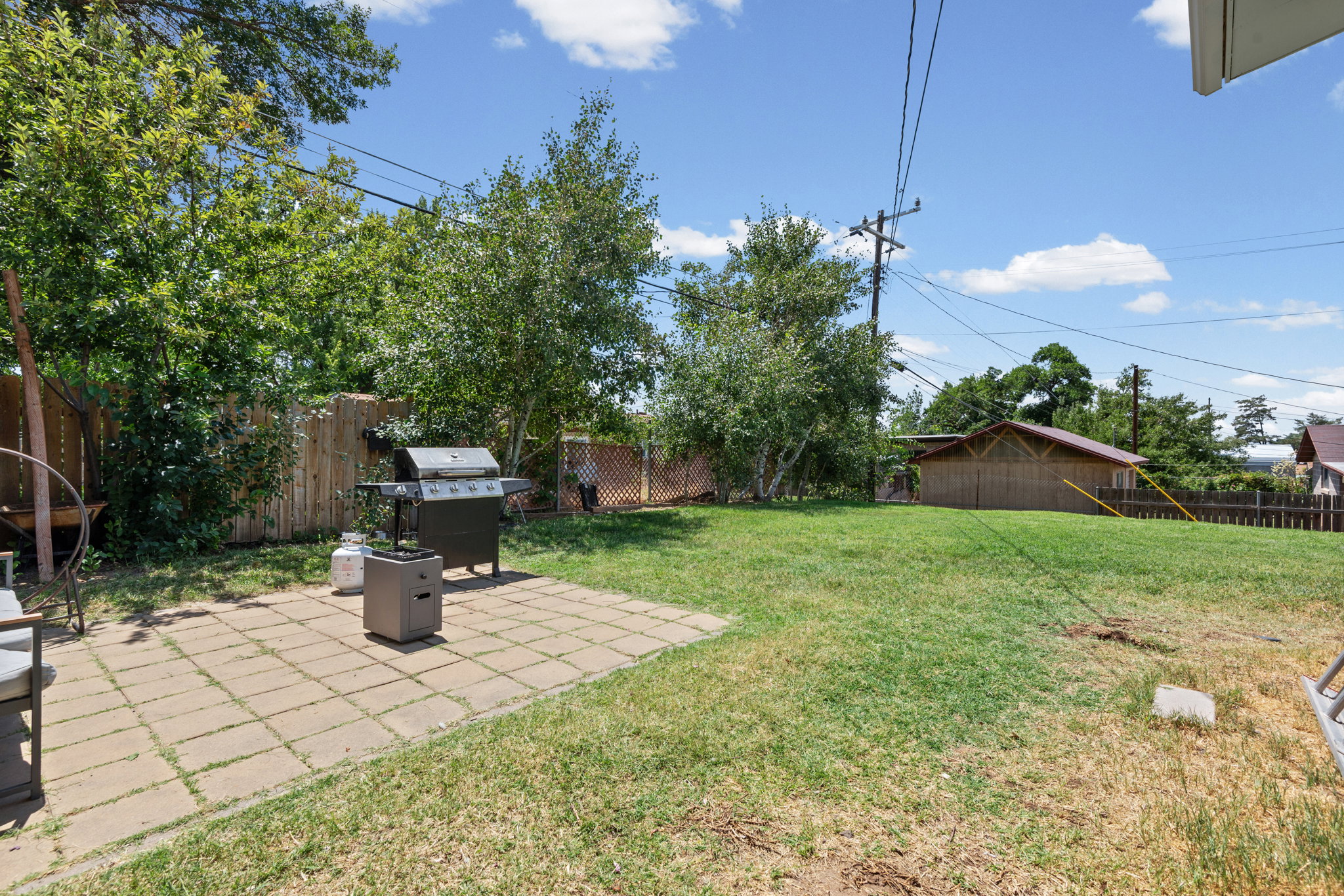 Expansive backyard featuring a paver patio and ample green space