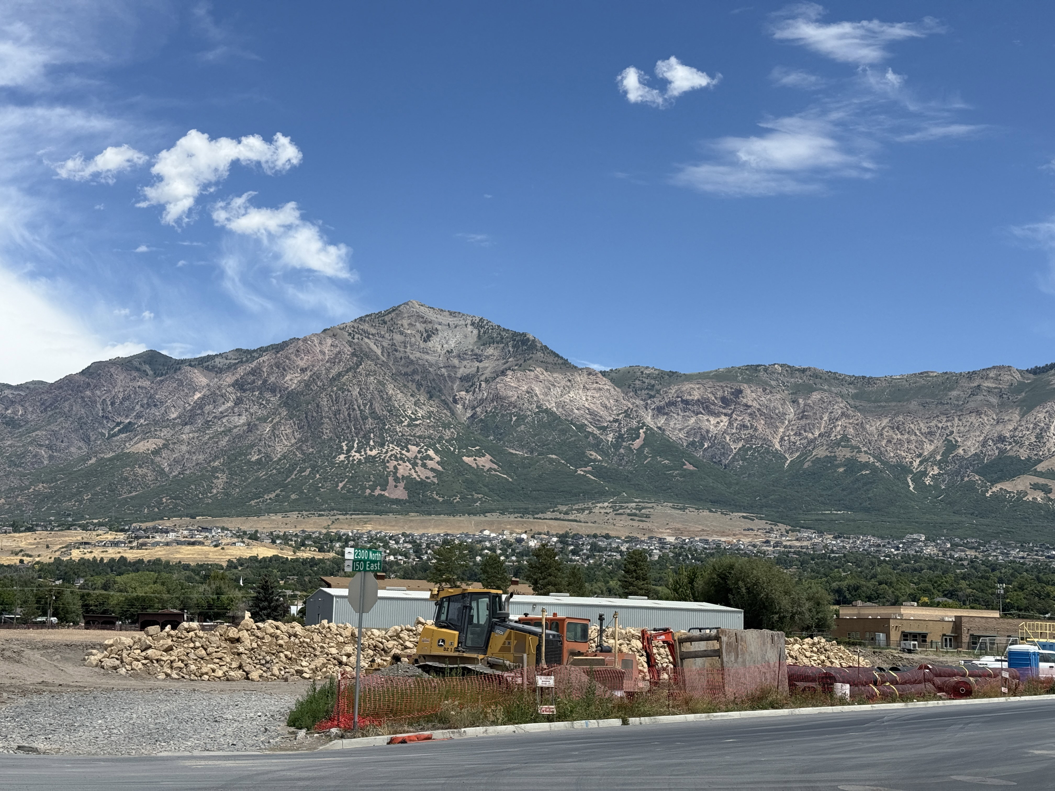 Expansive mountain backdrop with distant residential areas