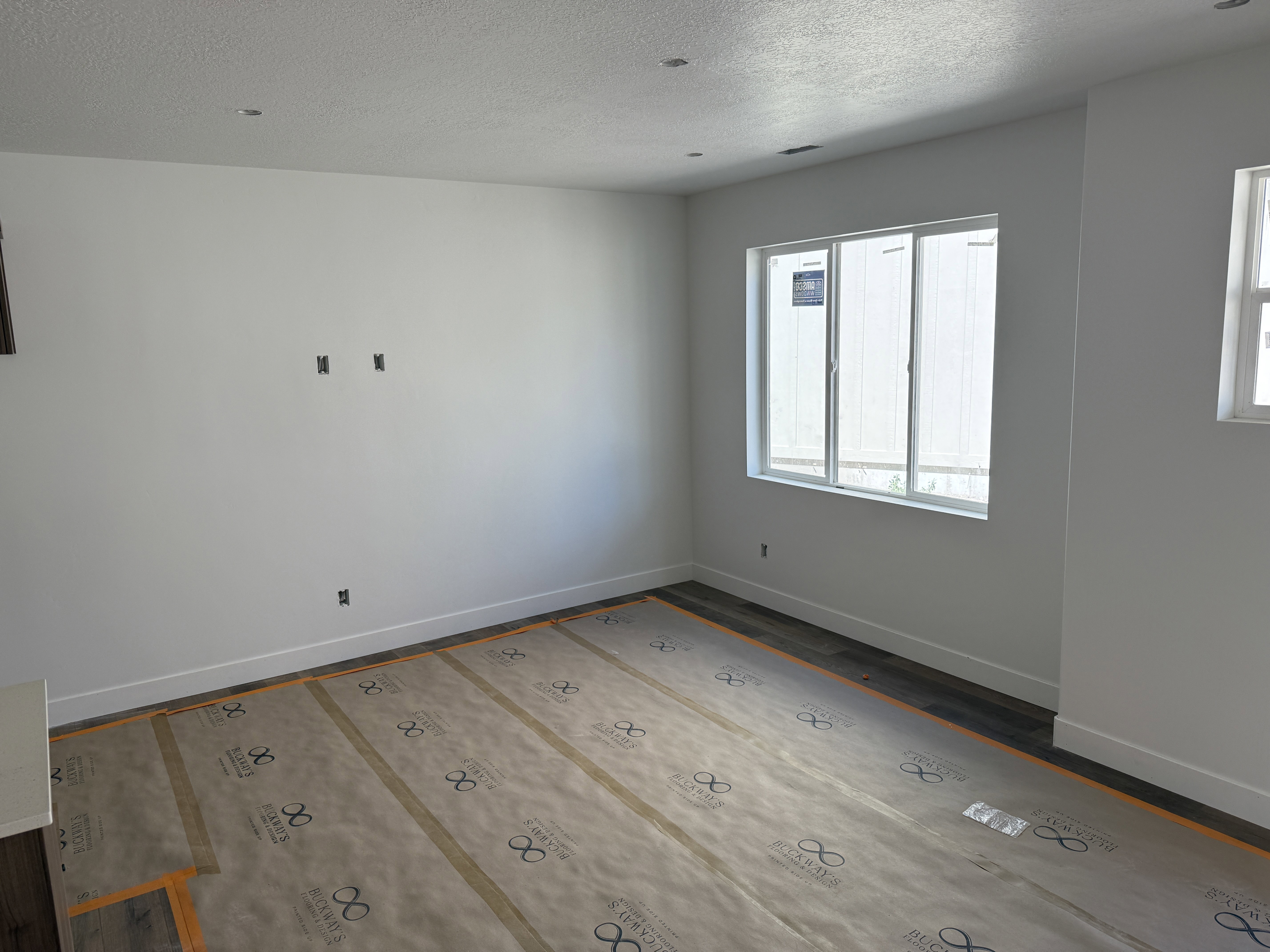 Bright interior space featuring white walls, recessed ceiling lighting, and a large window