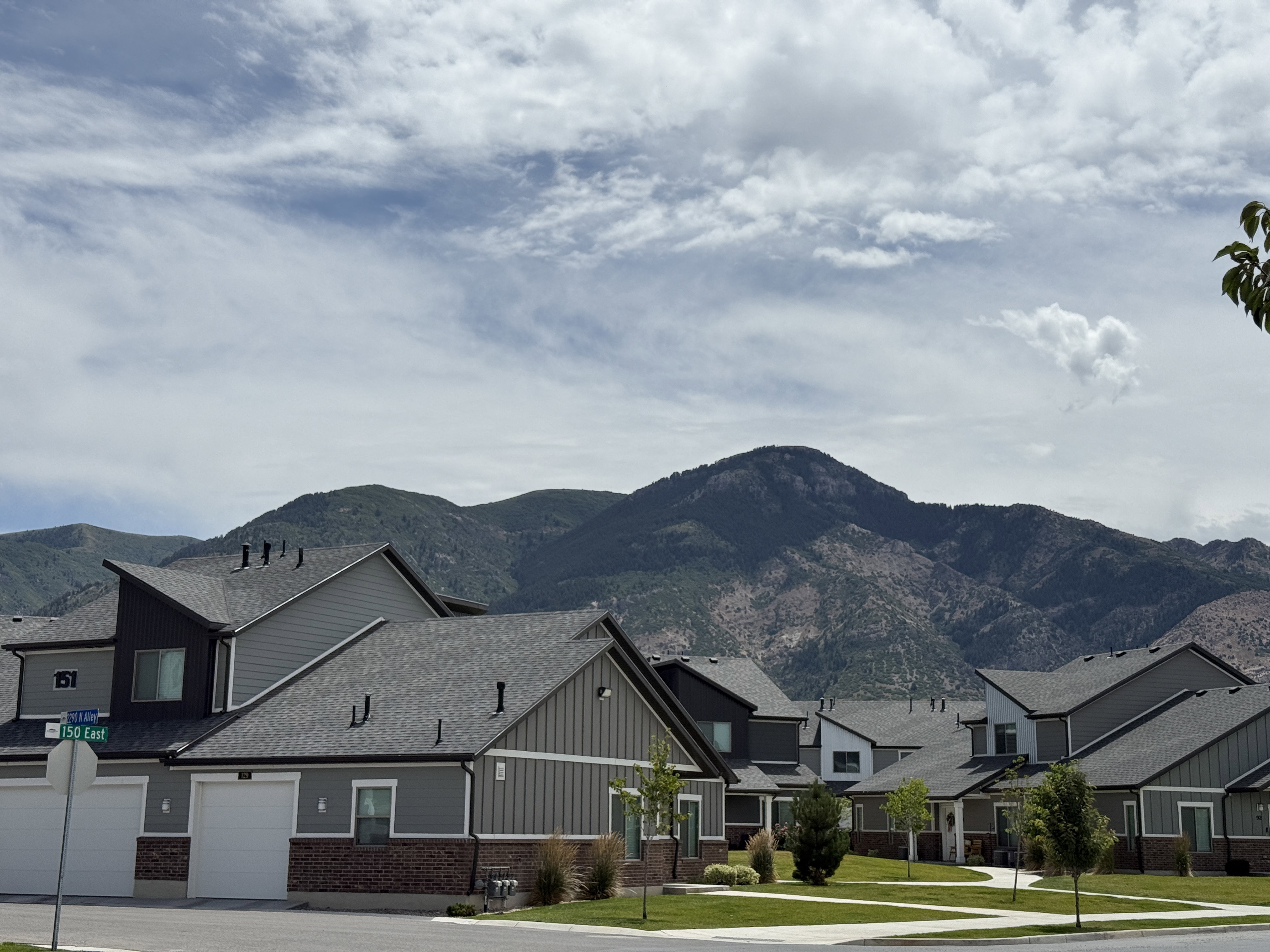 Townhome exterior featuring varied siding materials and a mountain backdrop