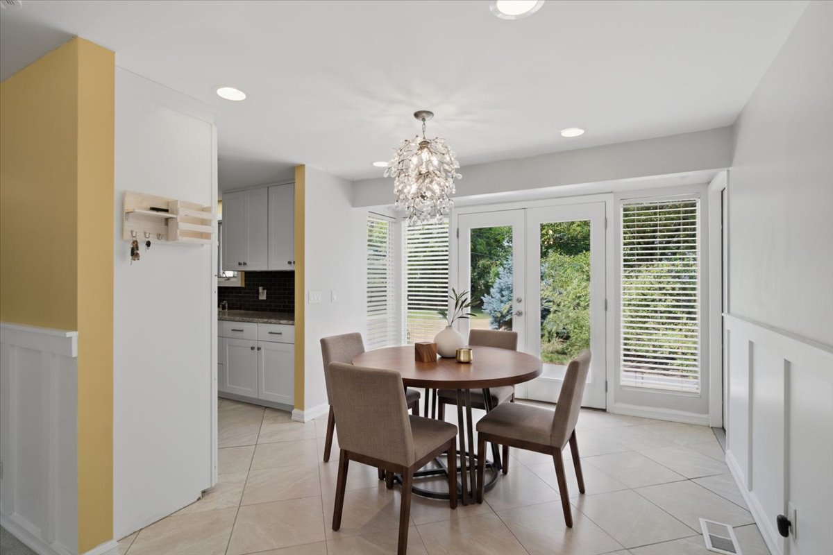 Dining area featuring a contemporary chandelier, recessed lighting, and tile flooring