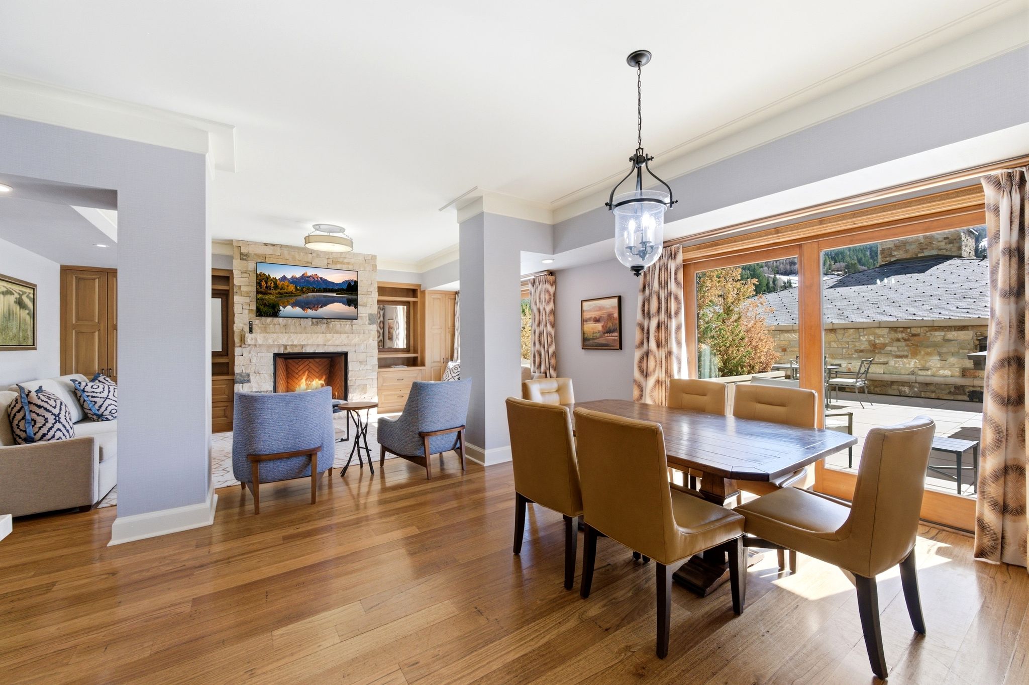 Expansive wood-finish flooring extending through the living and dining areas