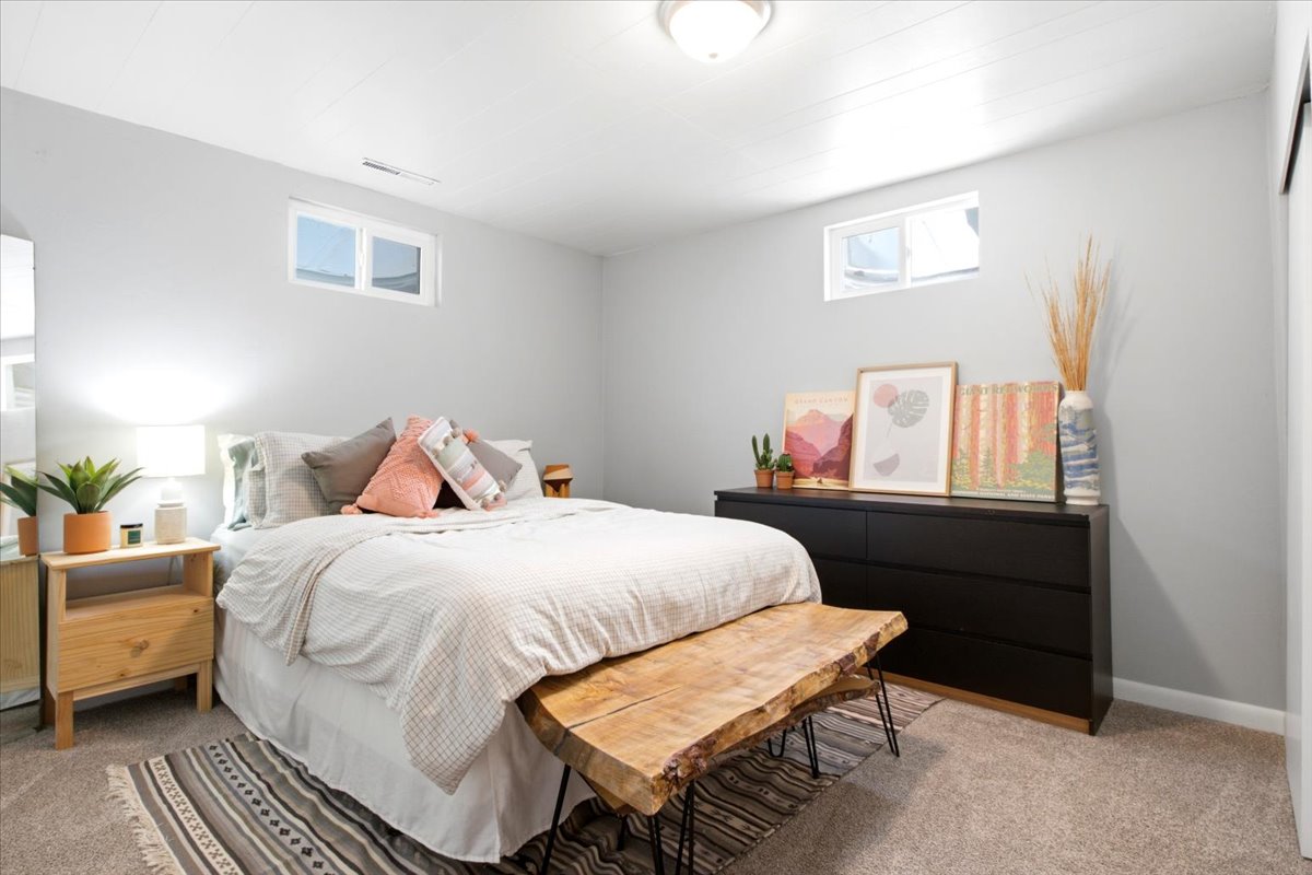 Light gray walls complement the neutral carpeting in this bedroom