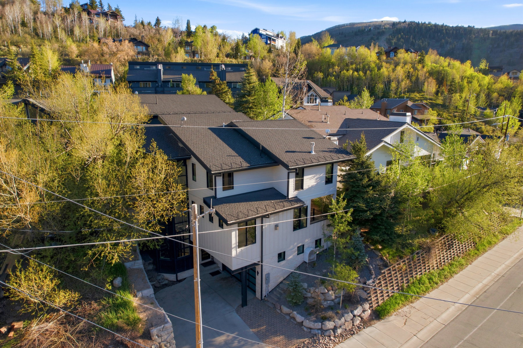 Contemporary multi-story residence featuring white siding and black trim