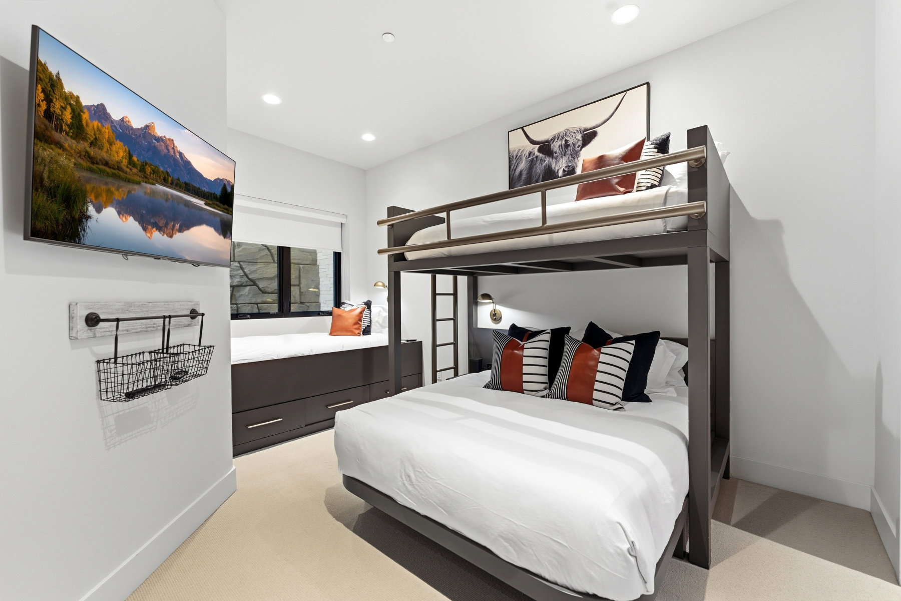 Bedroom featuring a built-in bunk bed with metal frame, integrated wall sconce lighting, and soft carpet flooring