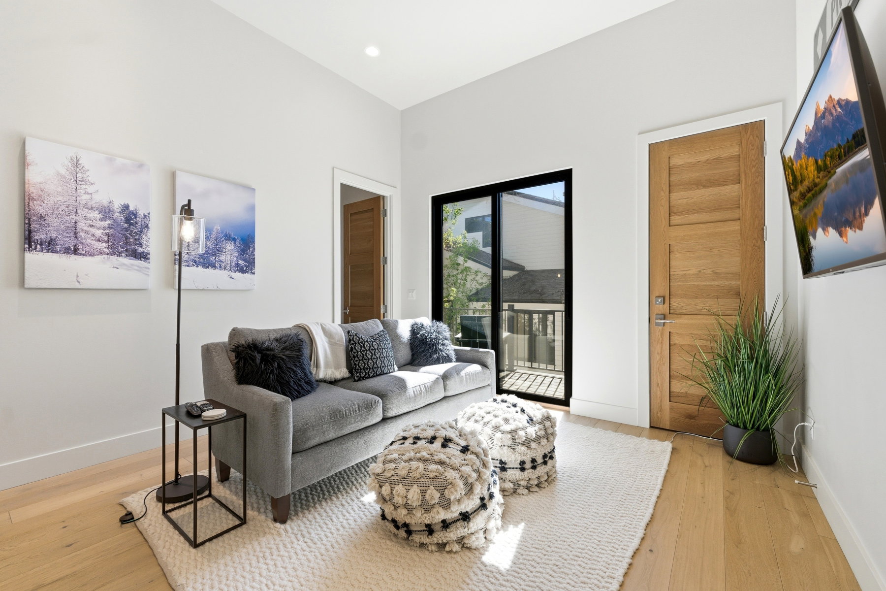 Light wood-finish flooring with a neutral area rug