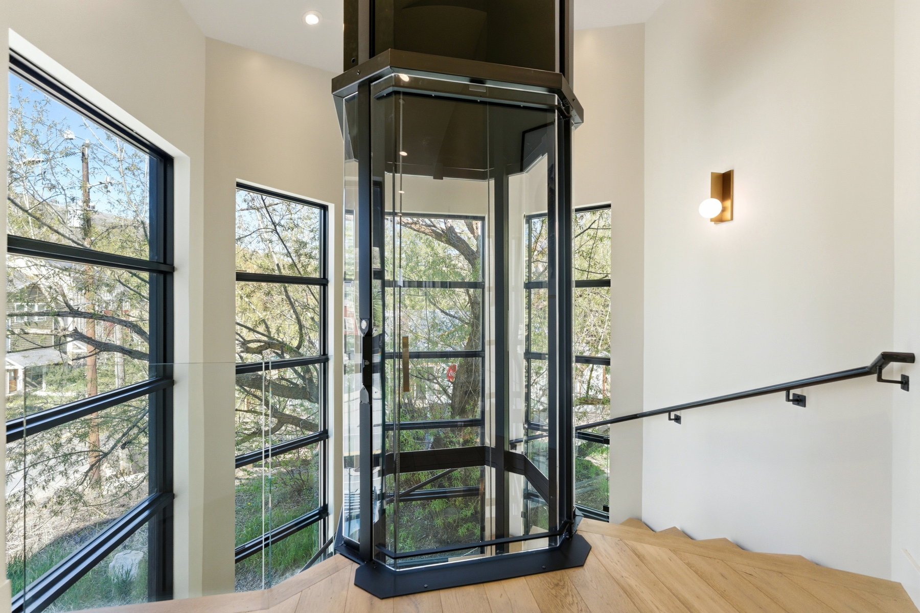 Contemporary glass elevator with black framing