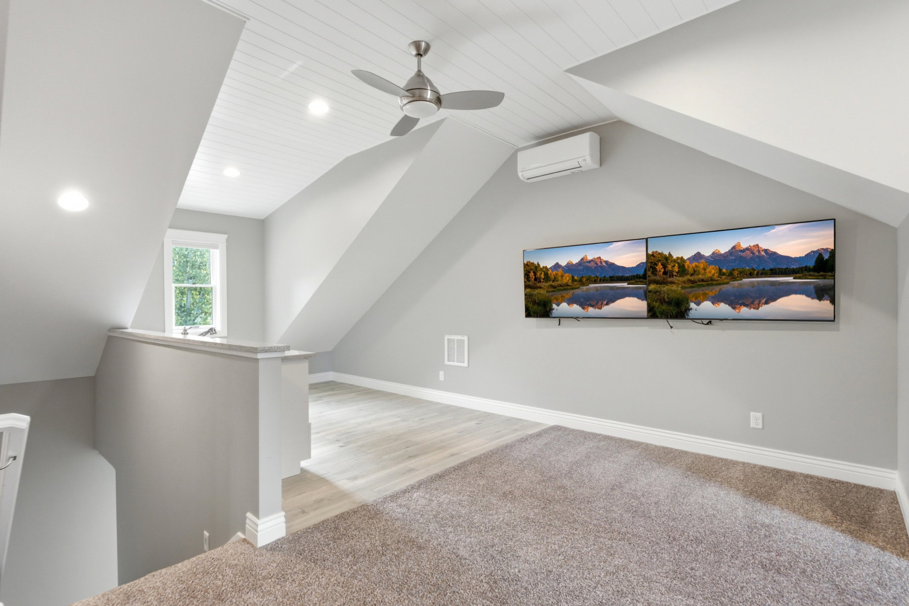 Spacious bonus room featuring an angled shiplap ceiling, recessed lighting, and a ceiling fan