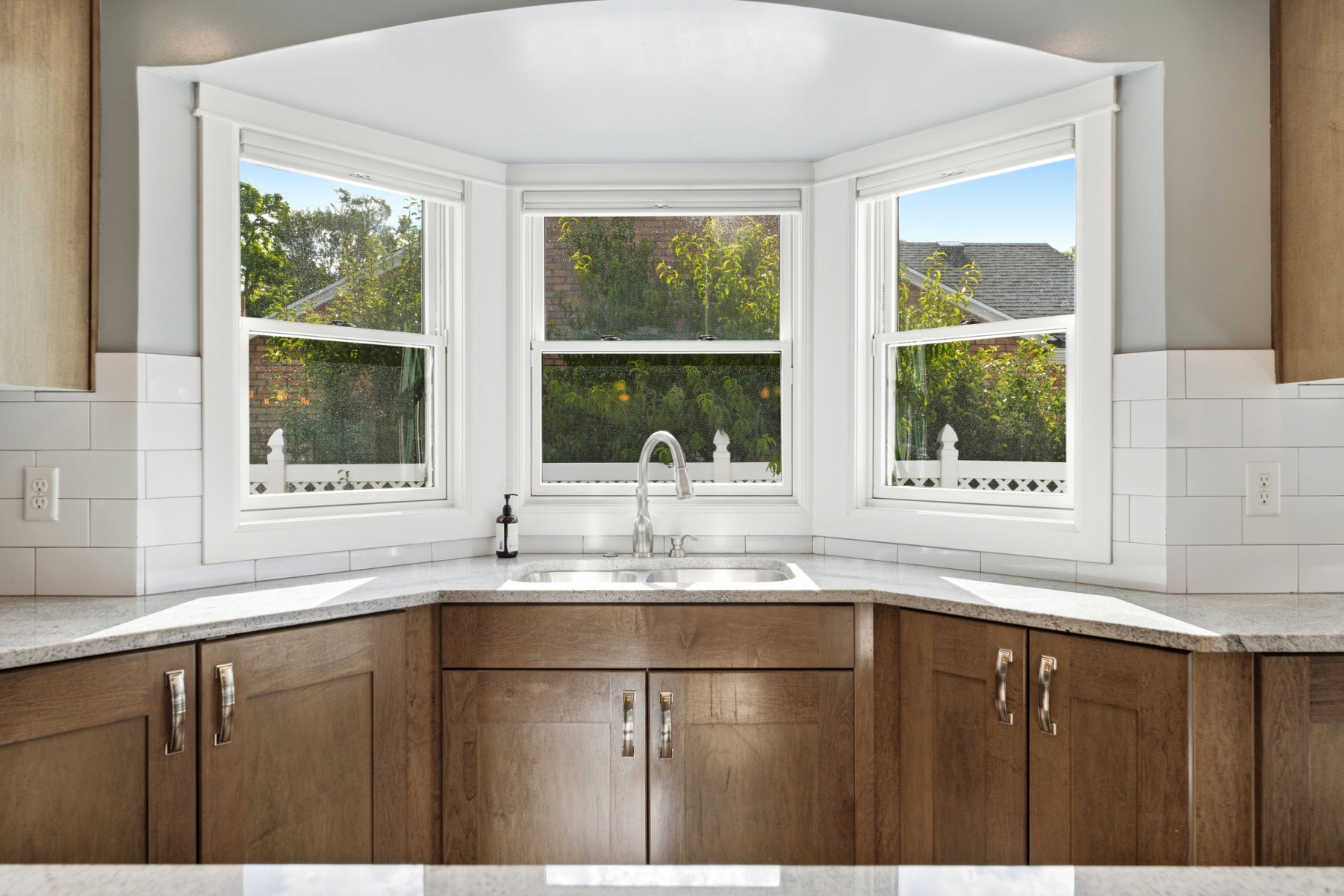Bay window with bright lighting overlooking a green space