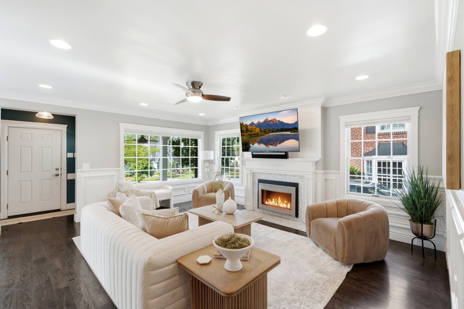 Living area featuring dark wood-finish flooring, recessed lighting, and a ceiling fan