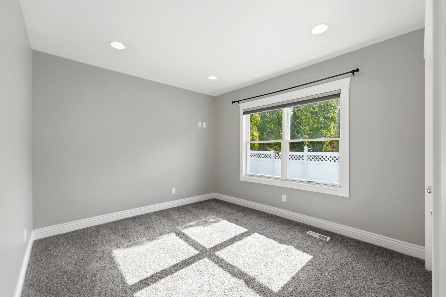 Neutral gray walls with white baseboards and trim