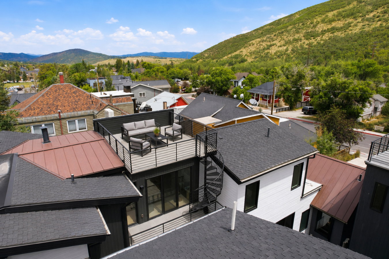 Rooftop deck featuring a horizontal slat privacy screen and black metal railings