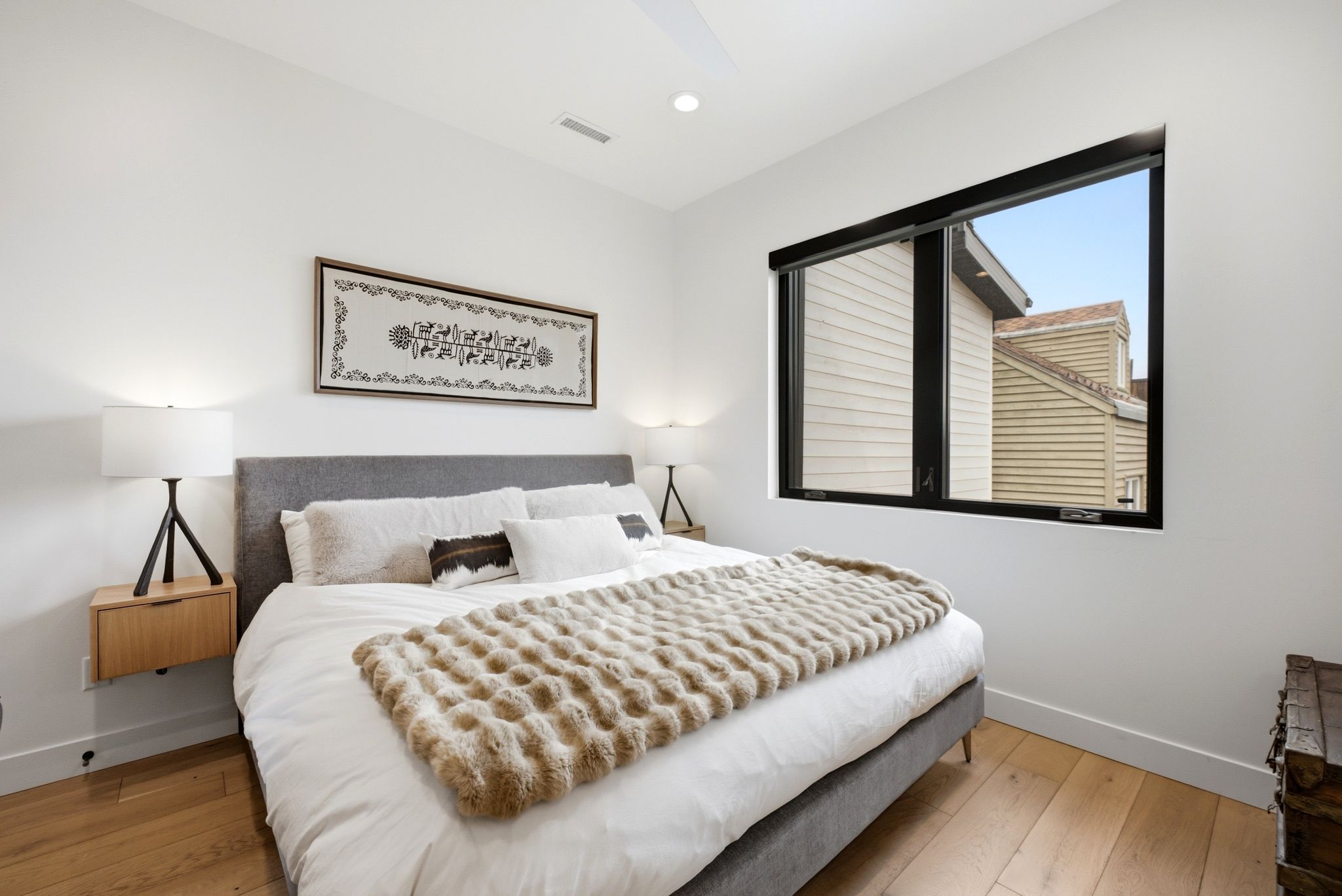 Bedroom featuring light wood-finish flooring, a large window with black framing, recessed lighting, and a contemporary ceiling fan