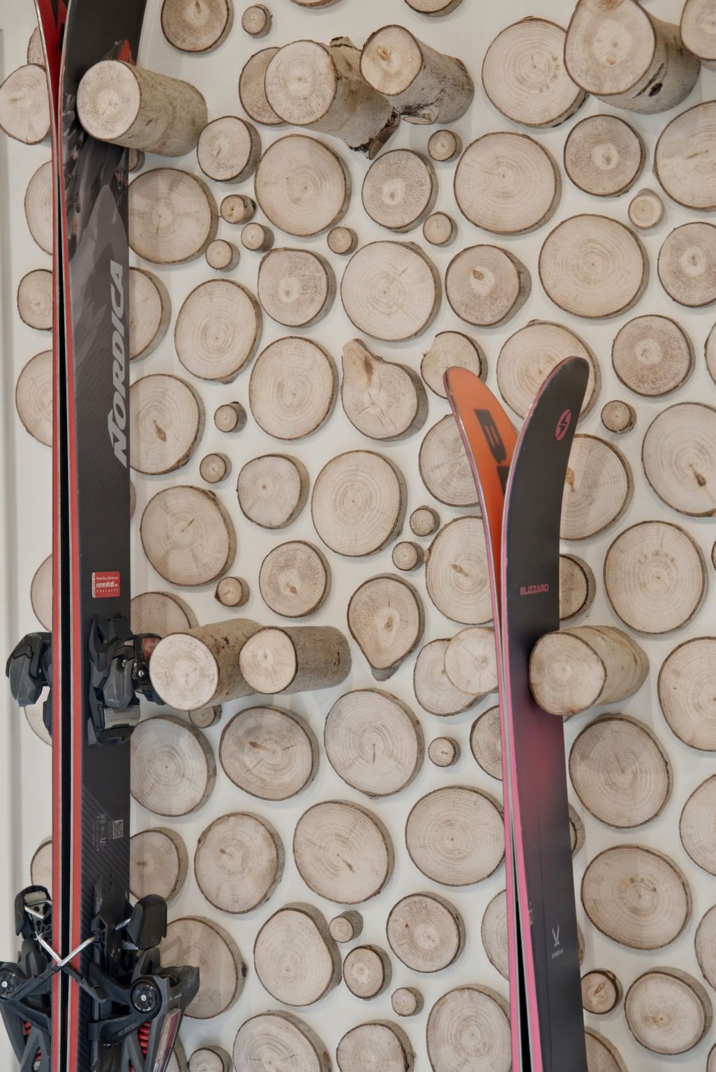 Decorative wall paneling crafted from varied wood slices, creating a rustic and textured surface