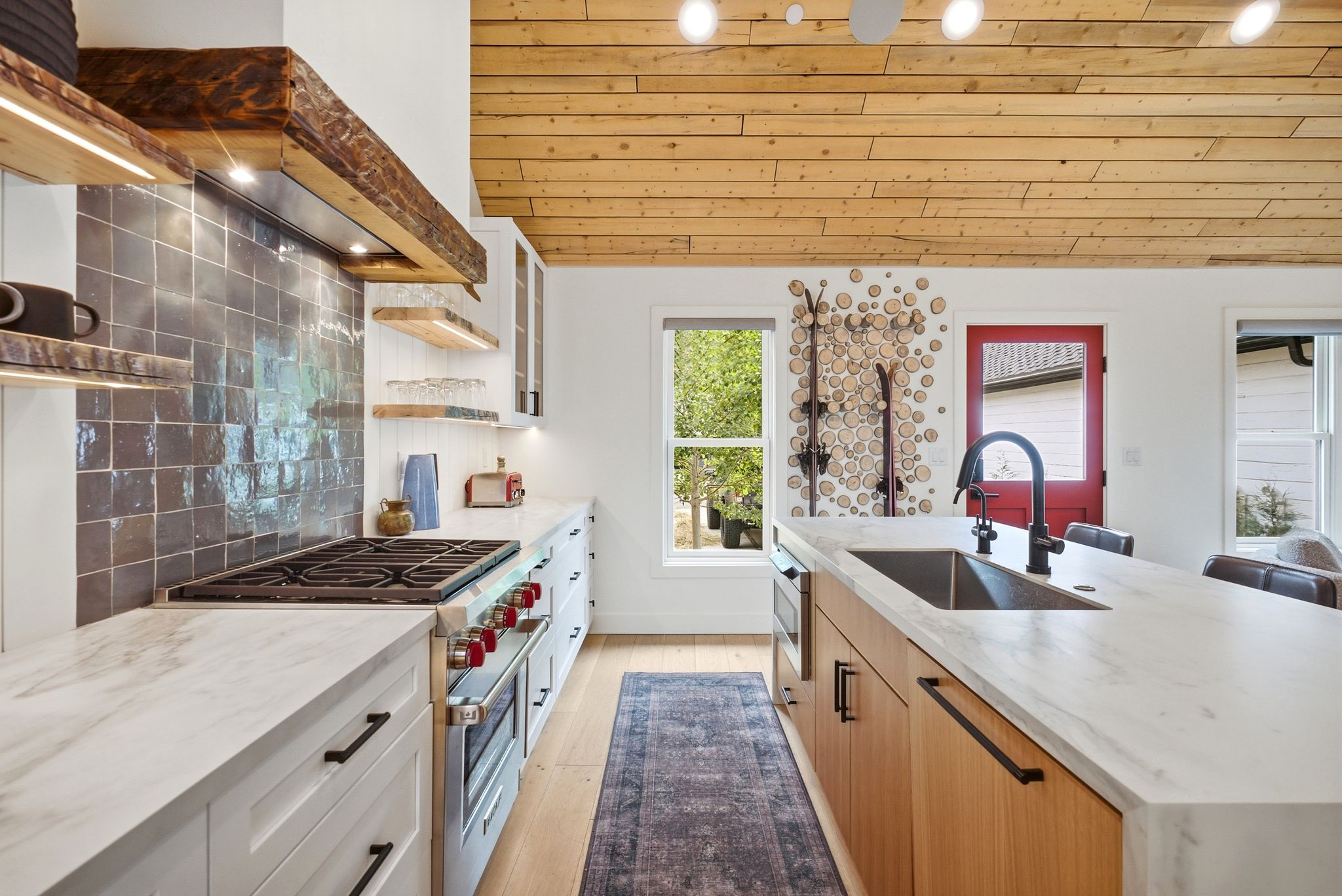 Modern kitchen featuring a wood plank ceiling, light wood-finish flooring, and white countertops