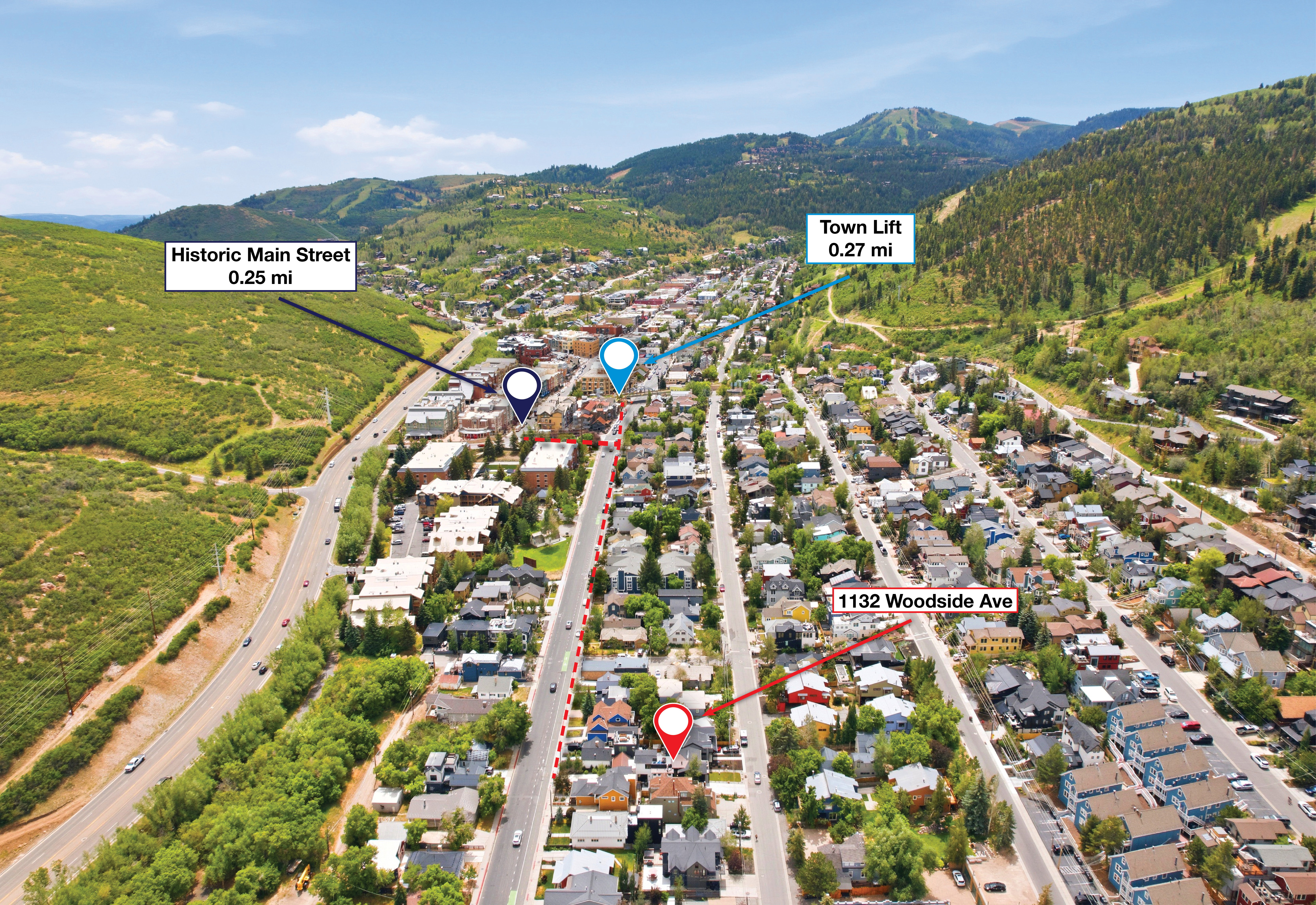 Aerial perspective showcasing a vibrant residential and commercial area nestled among green, mountainous terrain