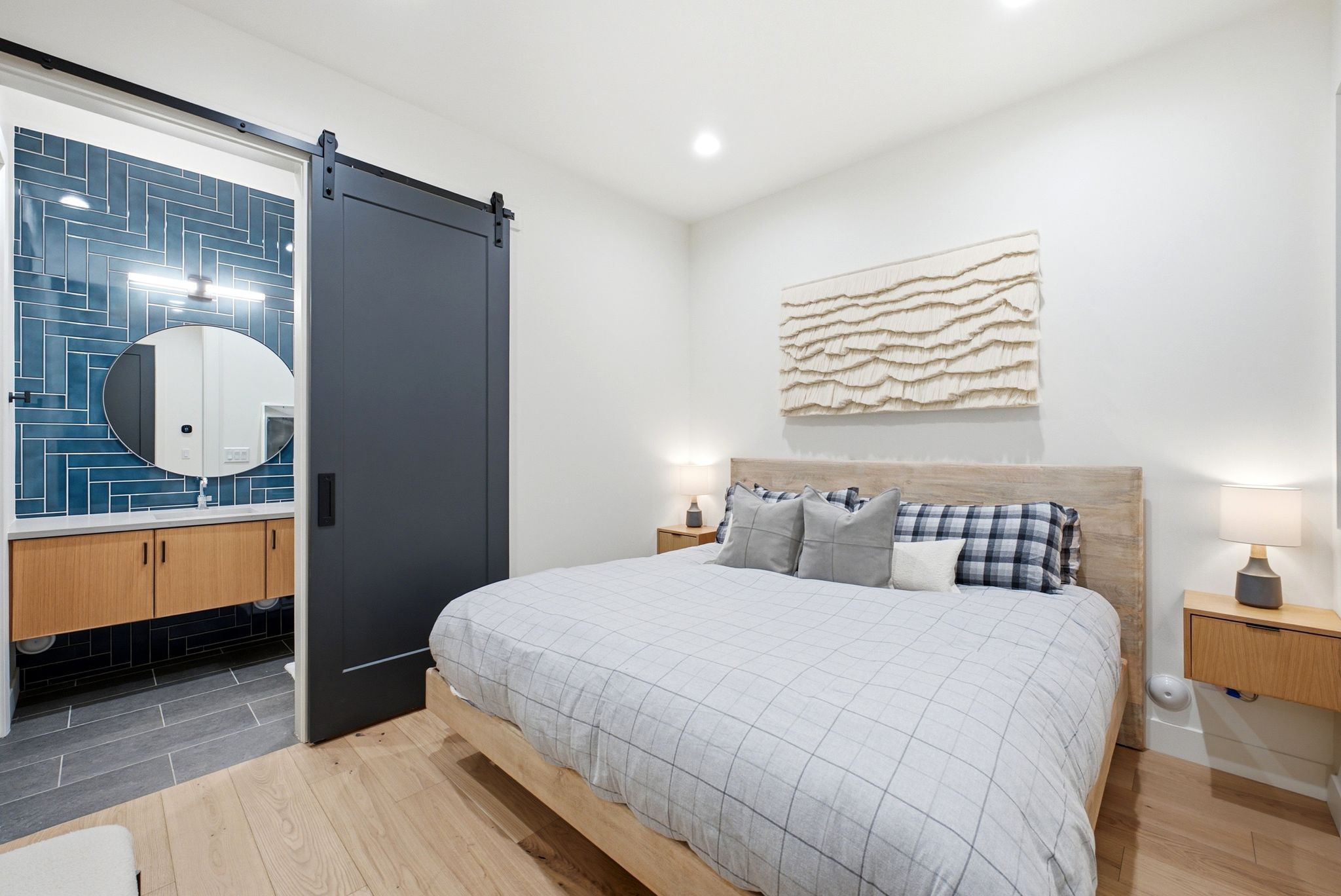 Recessed lighting illuminates wood-finish flooring