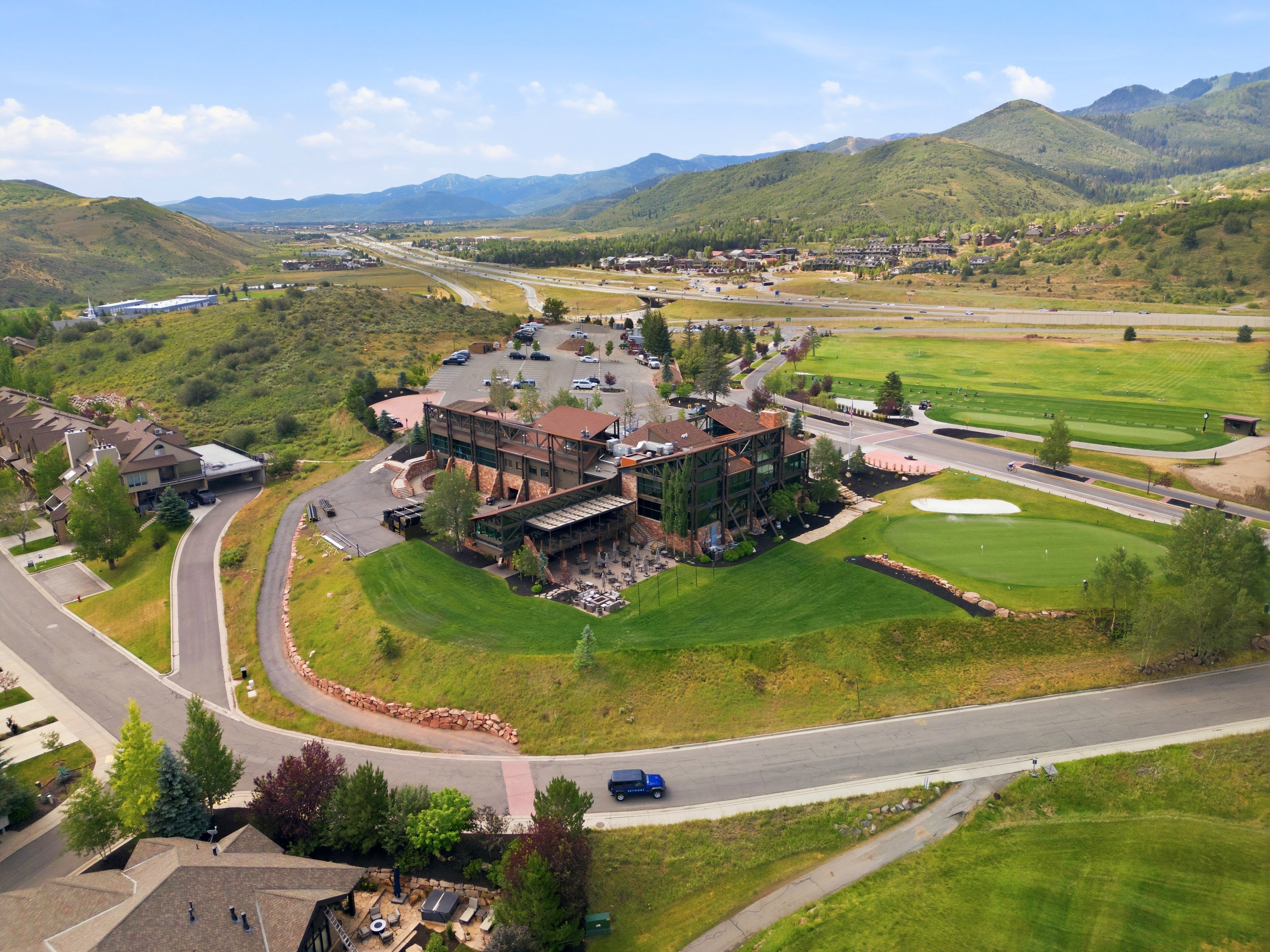 Expansive golf course setting featuring a putting green and sand trap