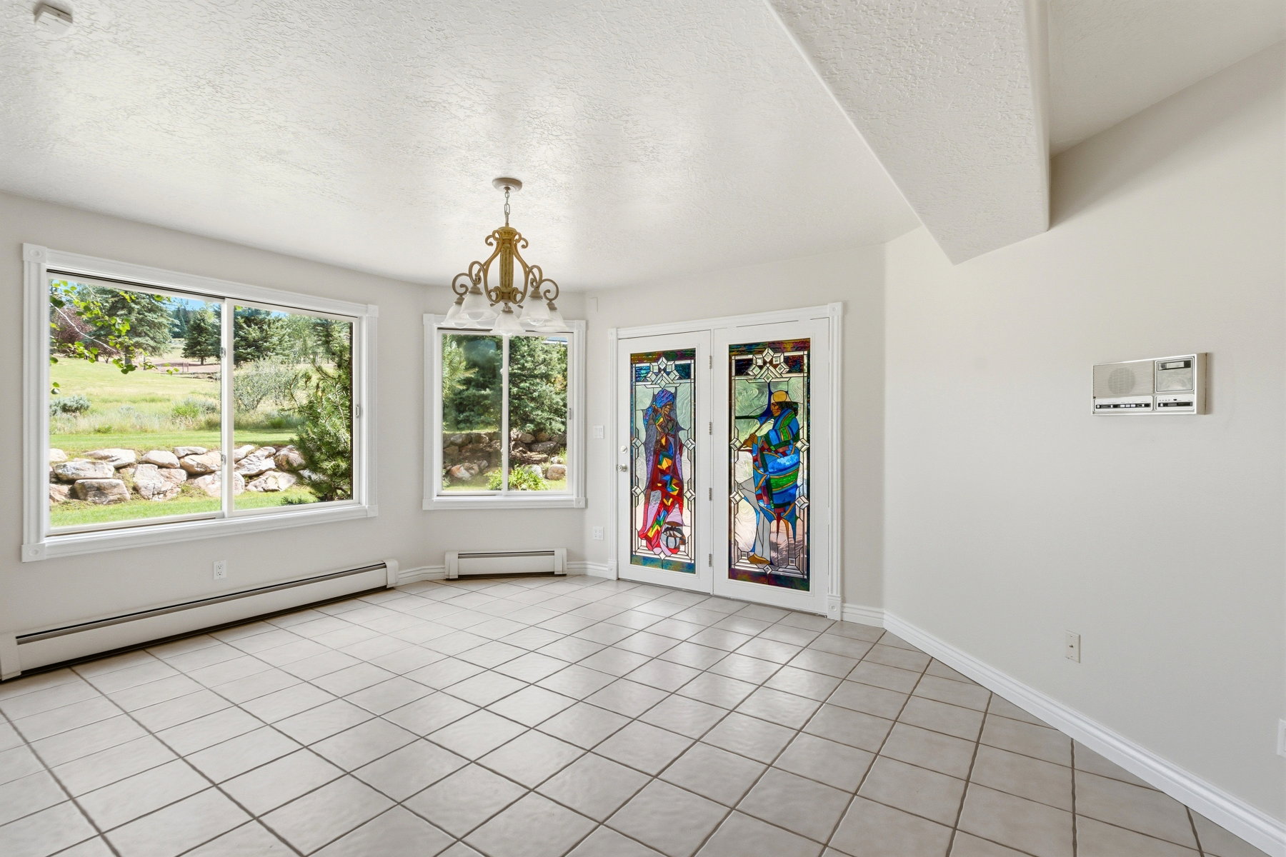Neutral-toned tiled flooring complemented by white walls and trim