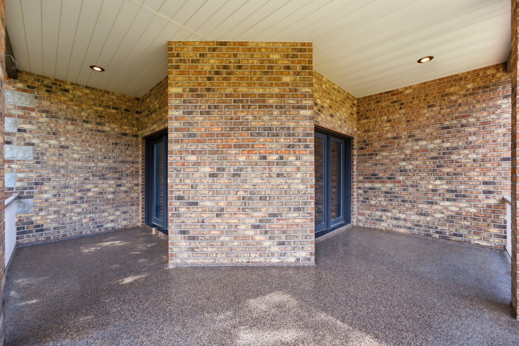 Expansive brick patio with a textured aggregate surface
