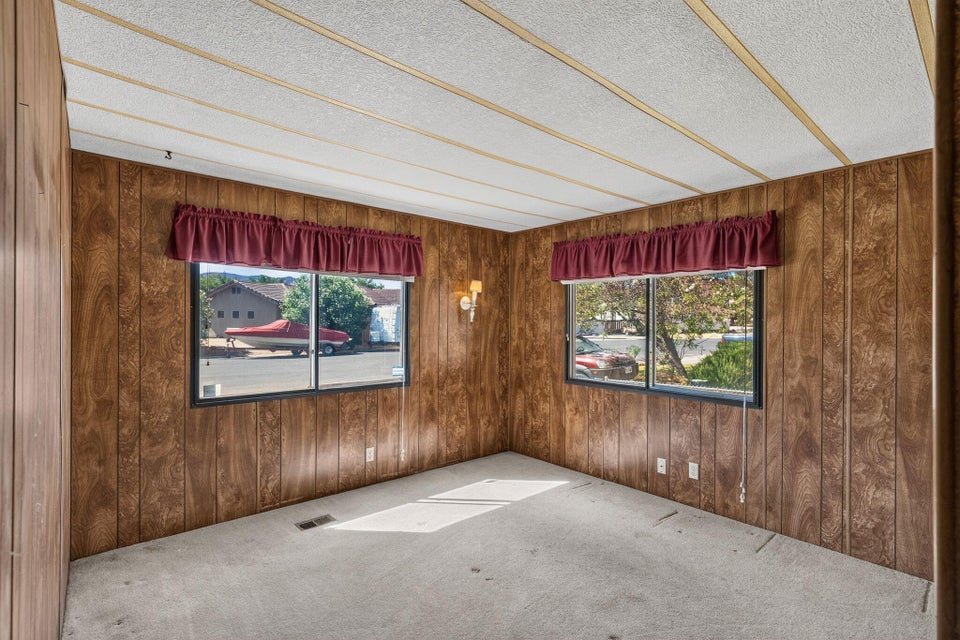 Interior space featuring wood-finish paneling and wall-to-wall carpeting