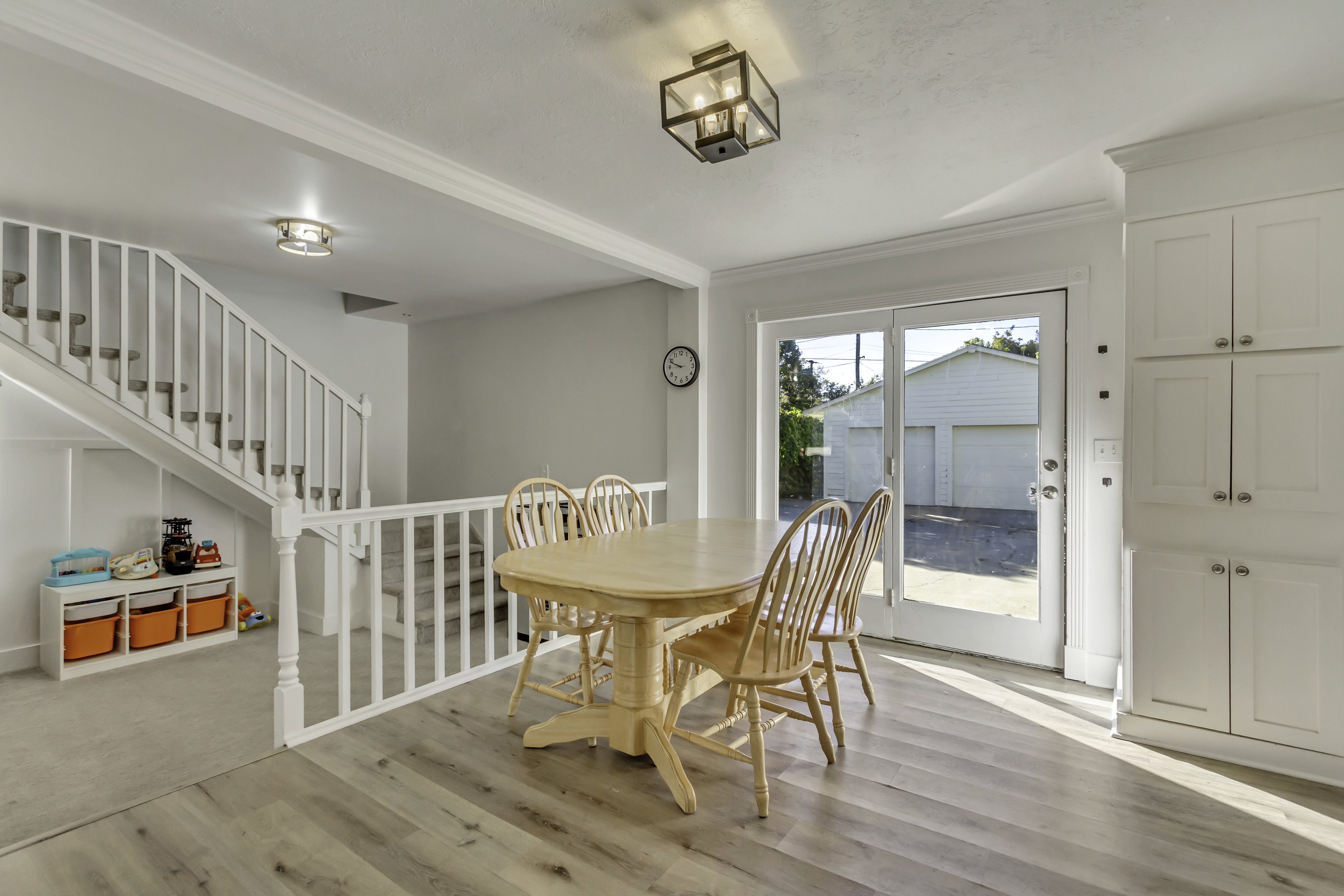 Light wood-finish flooring extending from the dining area to the entryway