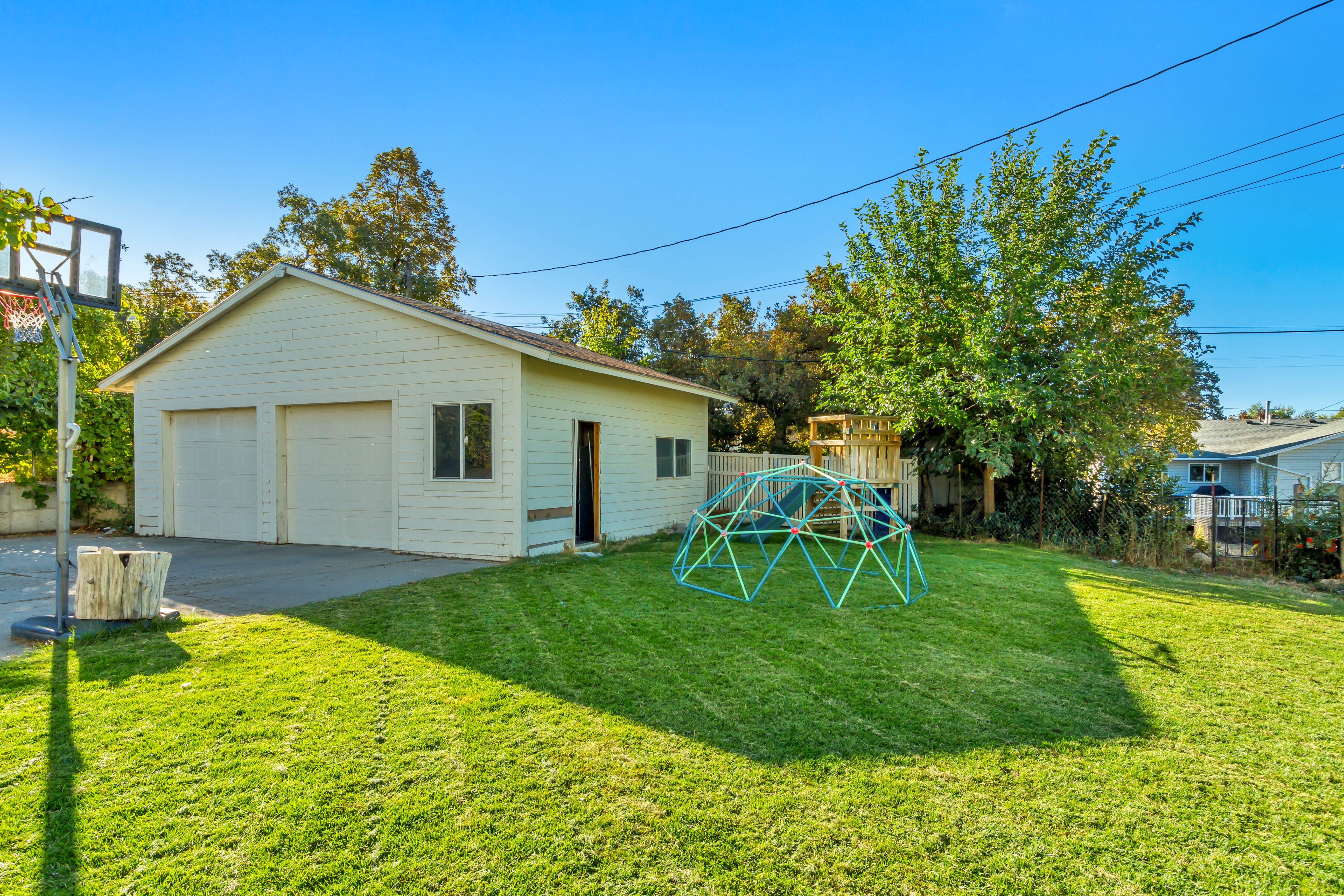 Detached two-car garage with white siding
