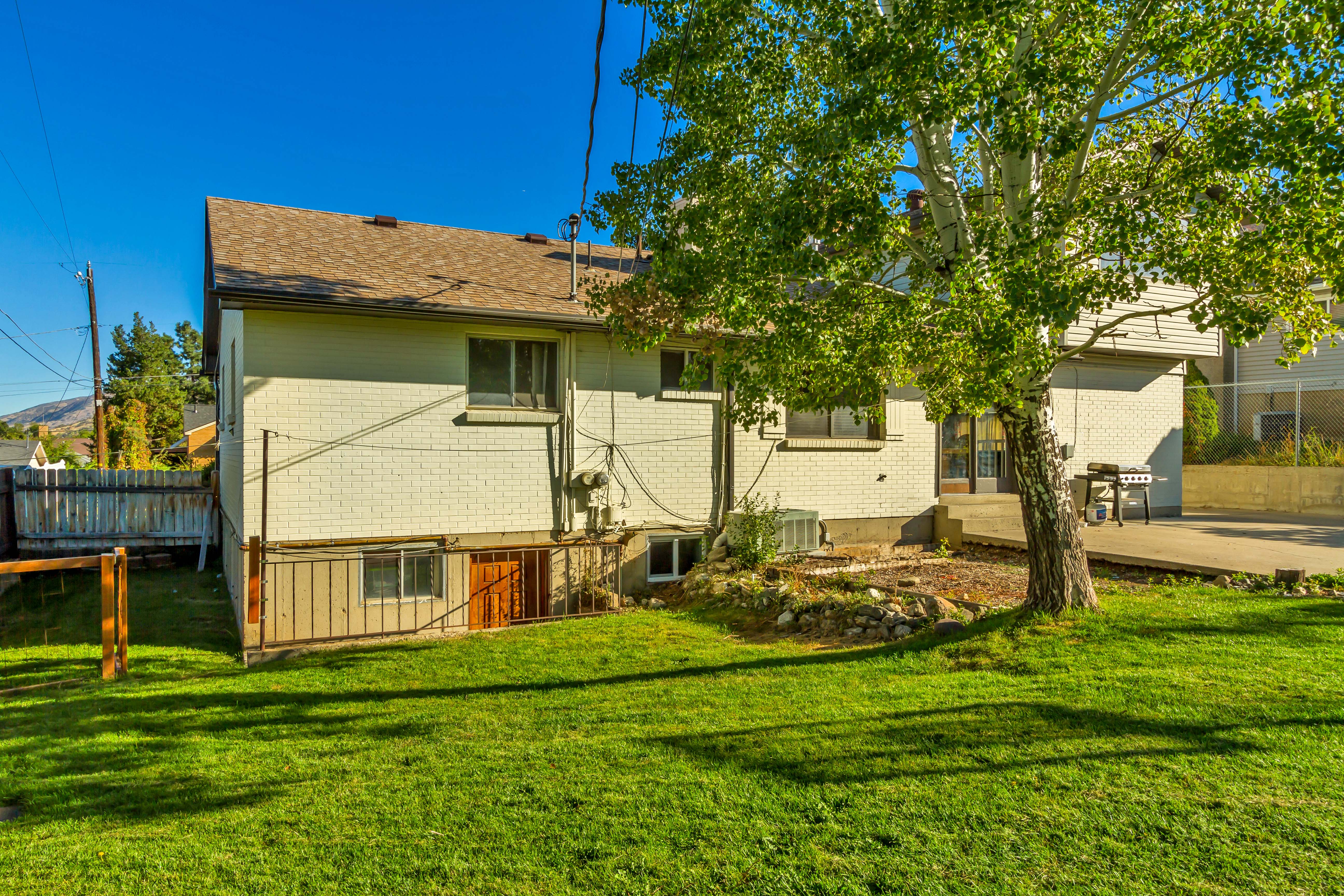 Expansive grassy yard with mature trees