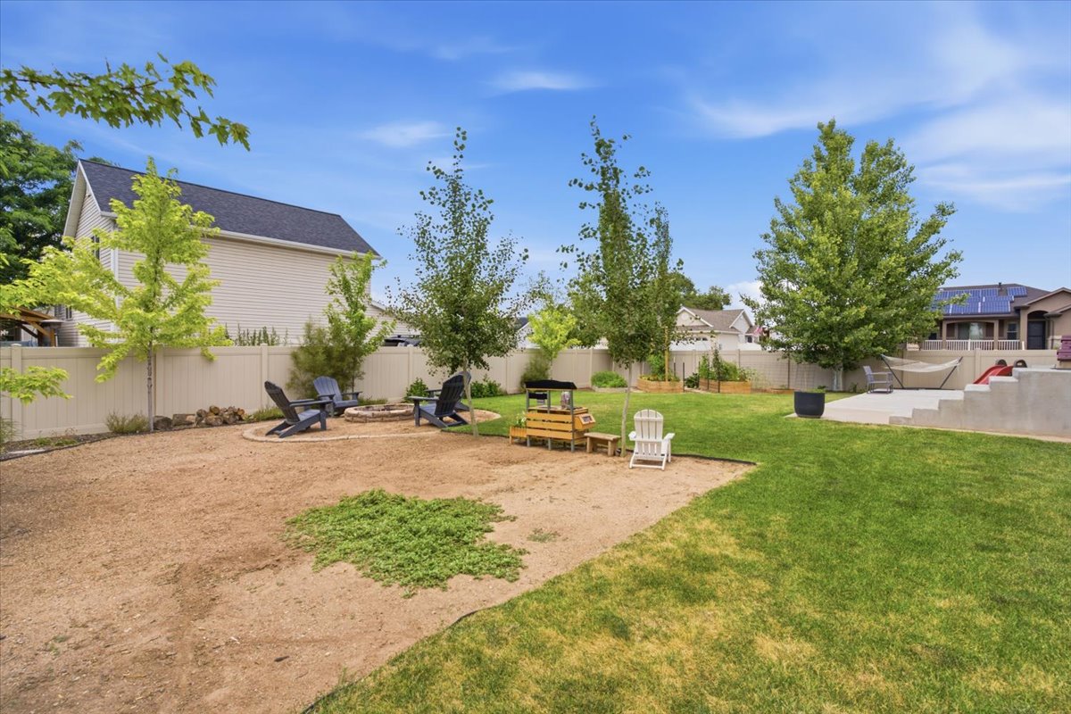 Expansive backyard featuring a combination of gravel and manicured lawn