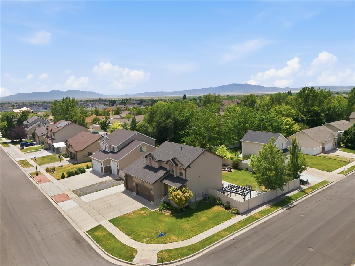 Aerial perspective showcasing a residential neighborhood with distant mountain scenery
