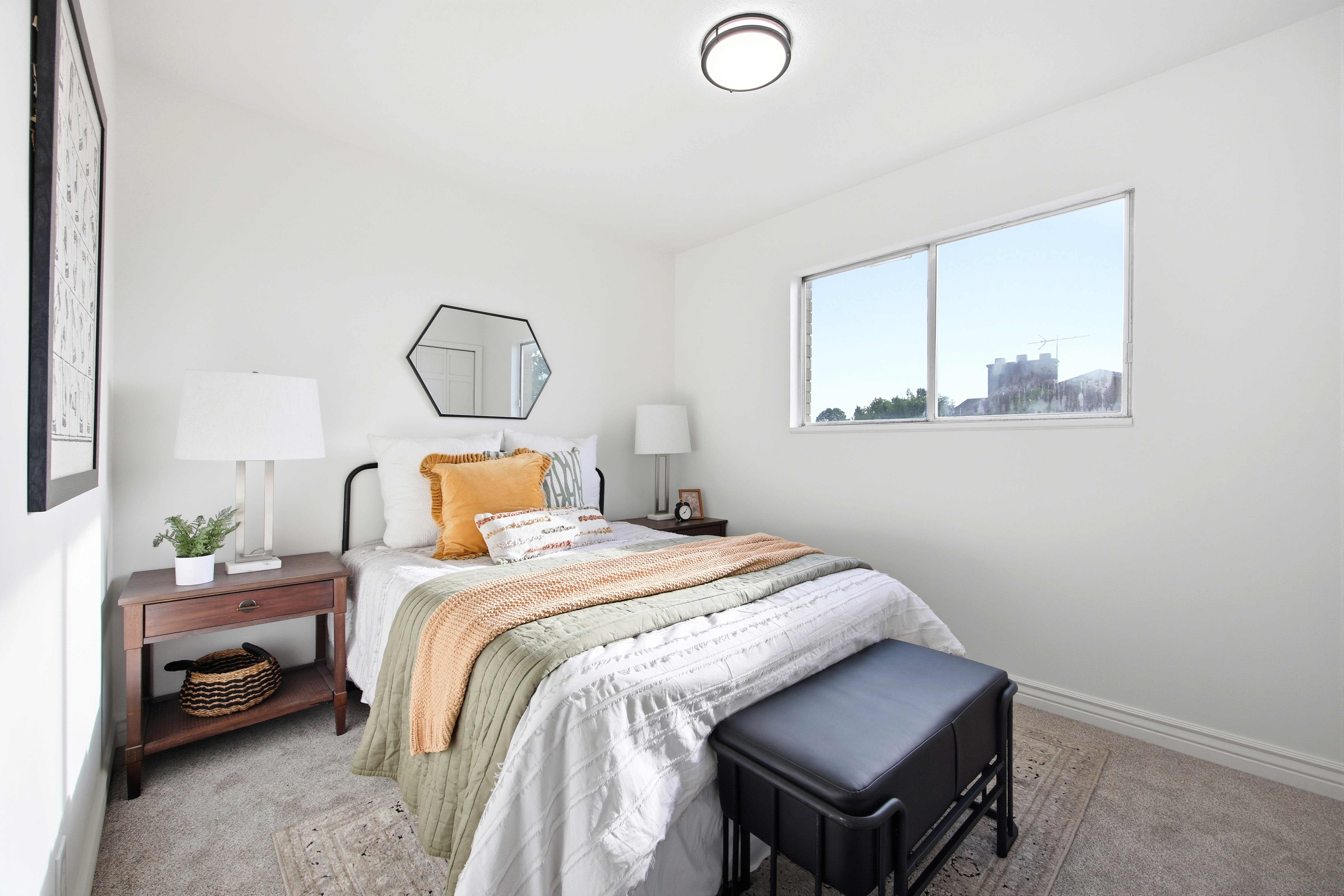 Bedroom featuring neutral wall colors, carpet flooring, a flush-mount ceiling light fixture, and a large window