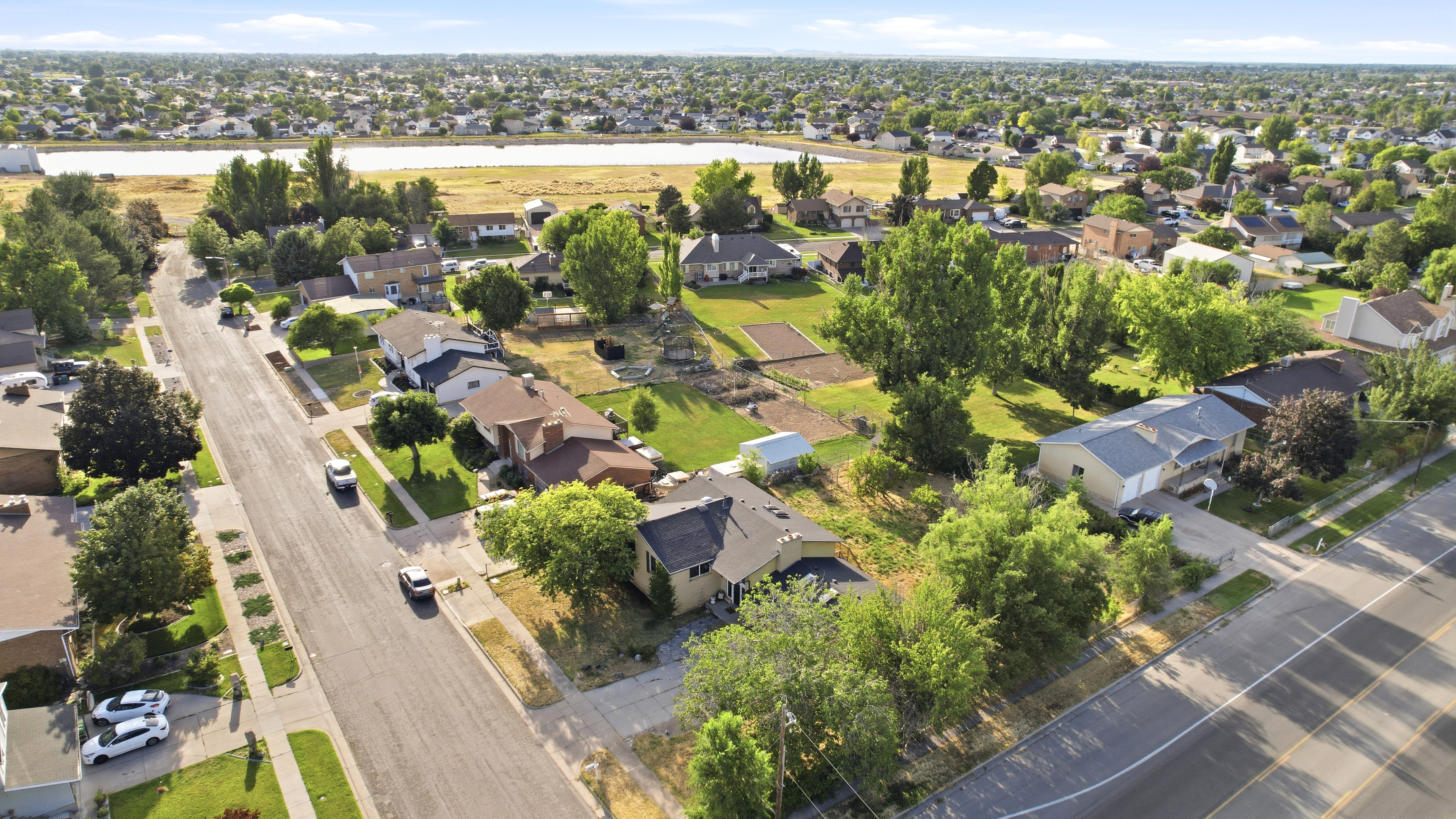 Residential streetscape featuring single-family homes with mature landscaping