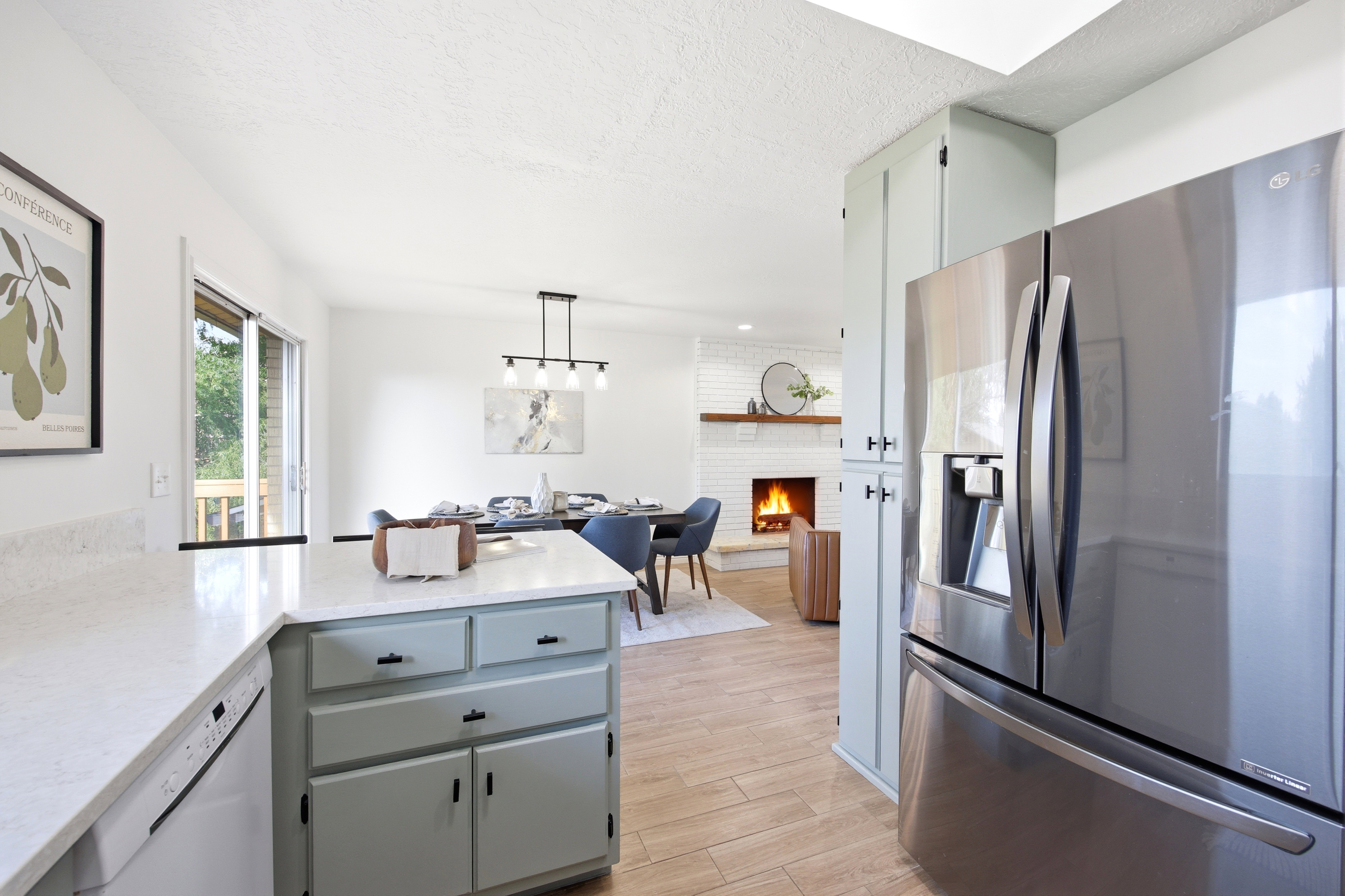 Kitchen island with light blue cabinetry and white countertops