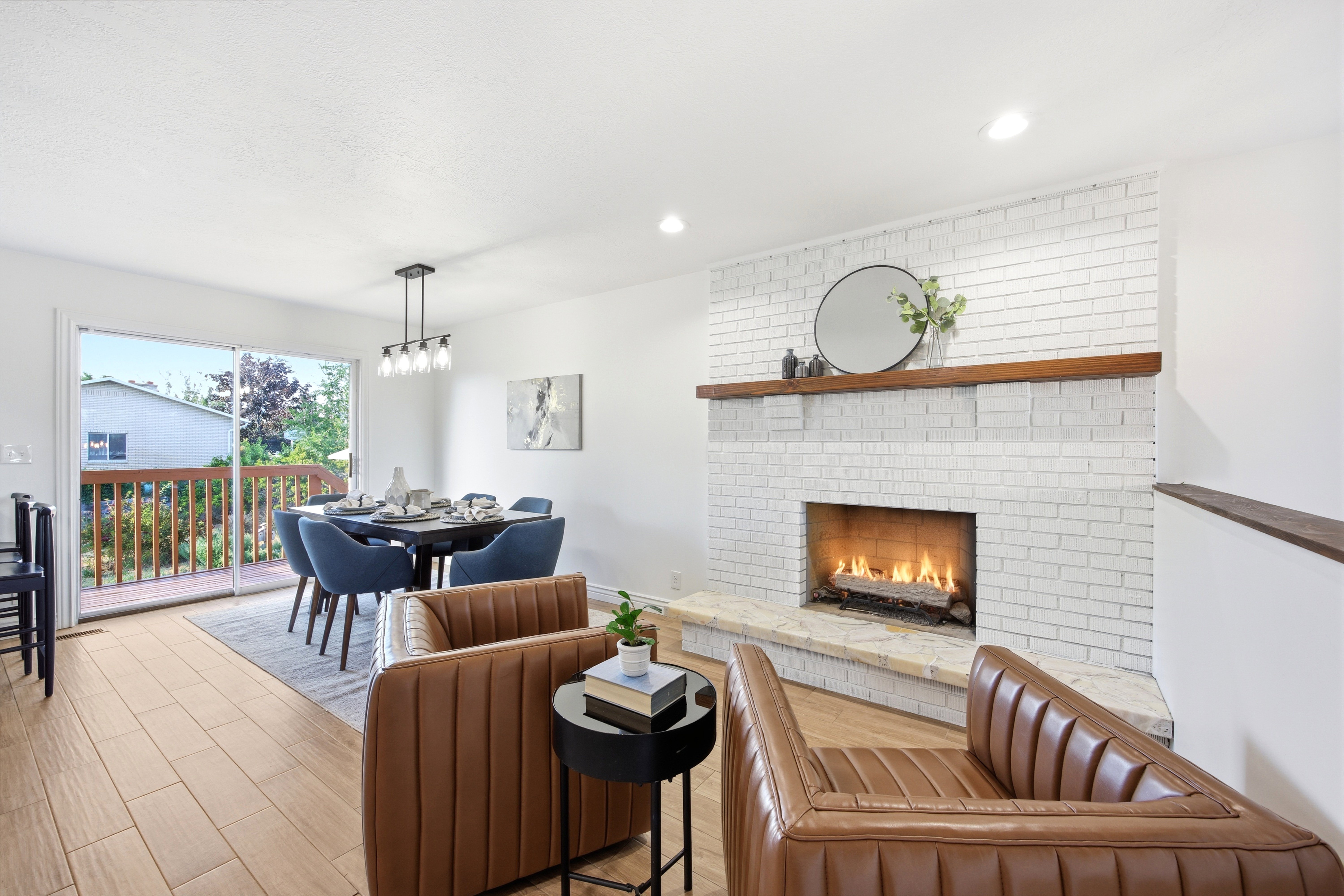 Living area featuring a painted brick fireplace with a wood mantel