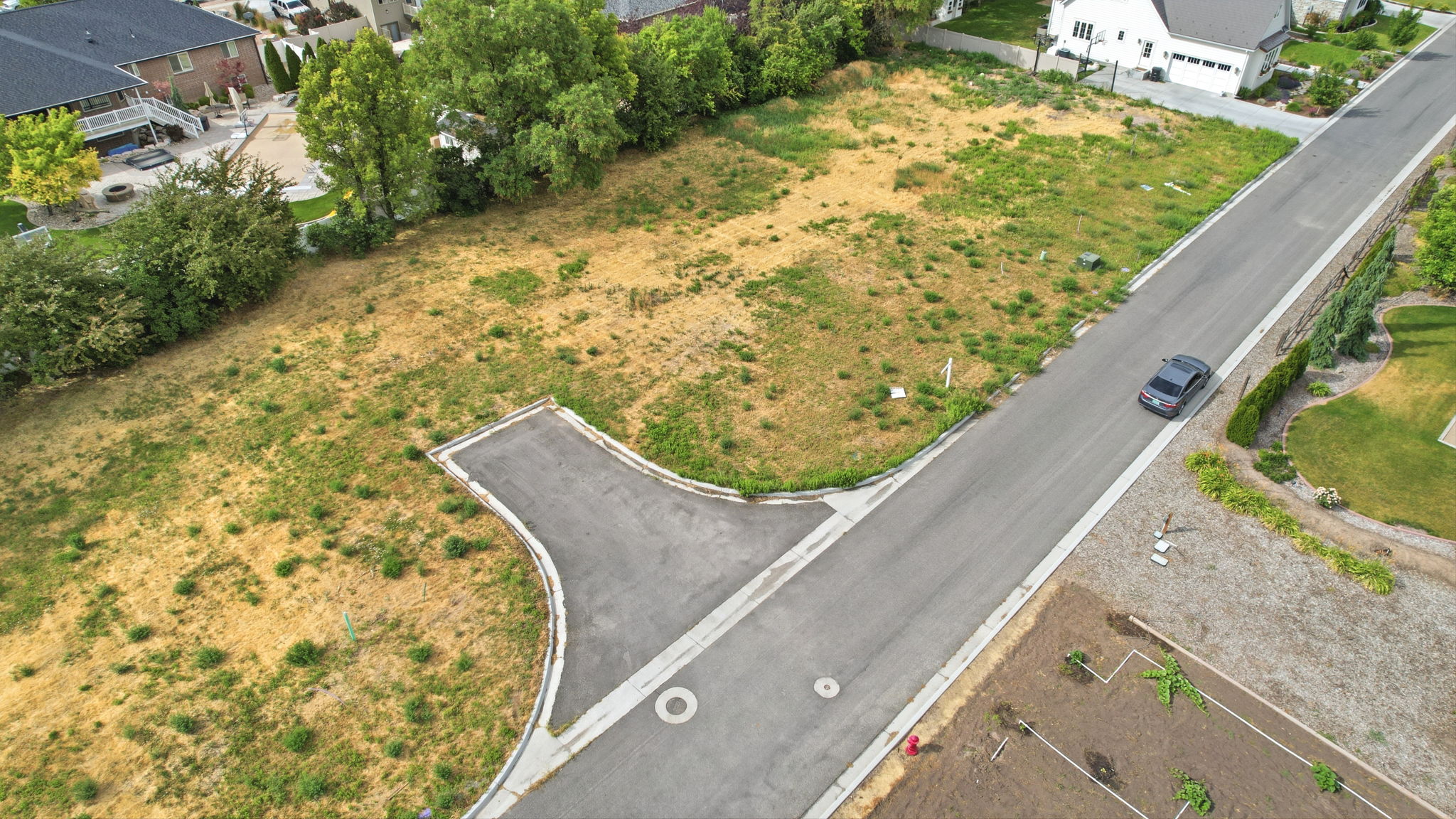 Expansive land parcel featuring existing street infrastructure and a cul-de-sac