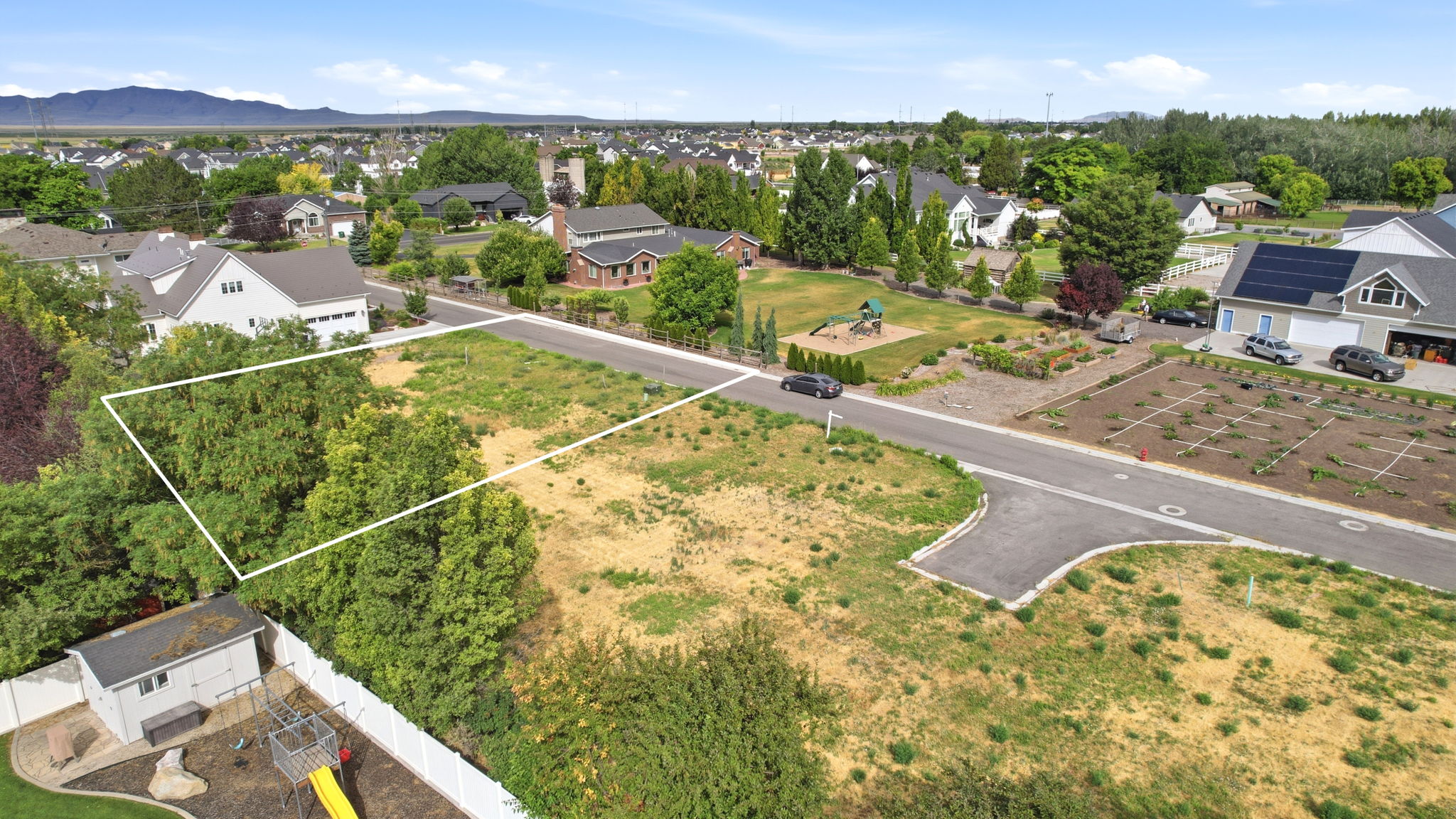 Expansive lot featuring mature trees and a clear buildable area