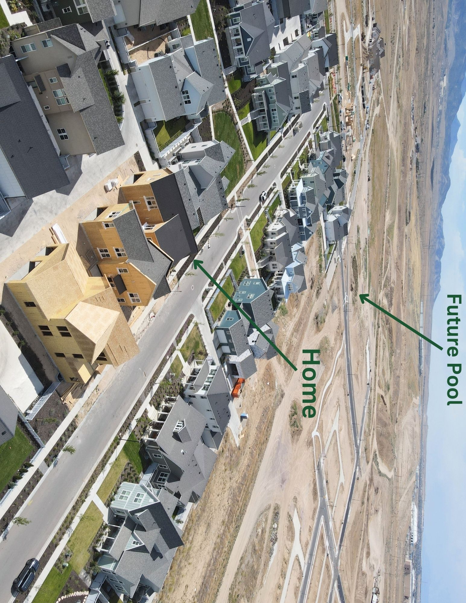 Newly constructed residential community featuring a variety of architectural styles, paved streets, and landscaped front yards