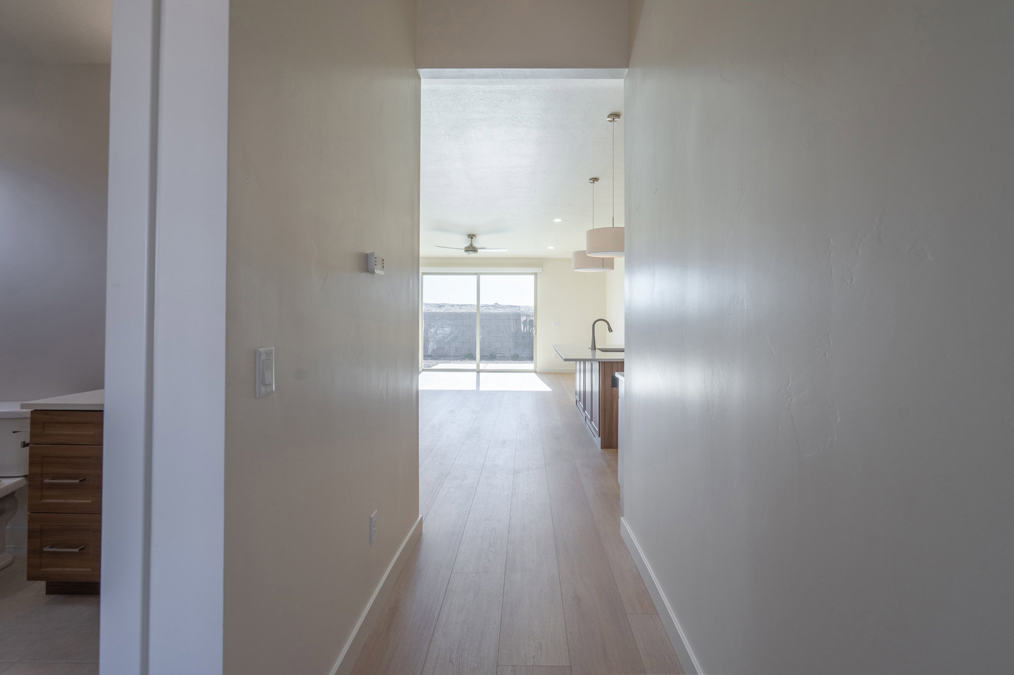 Corridor with baseboards and light wood-type flooring