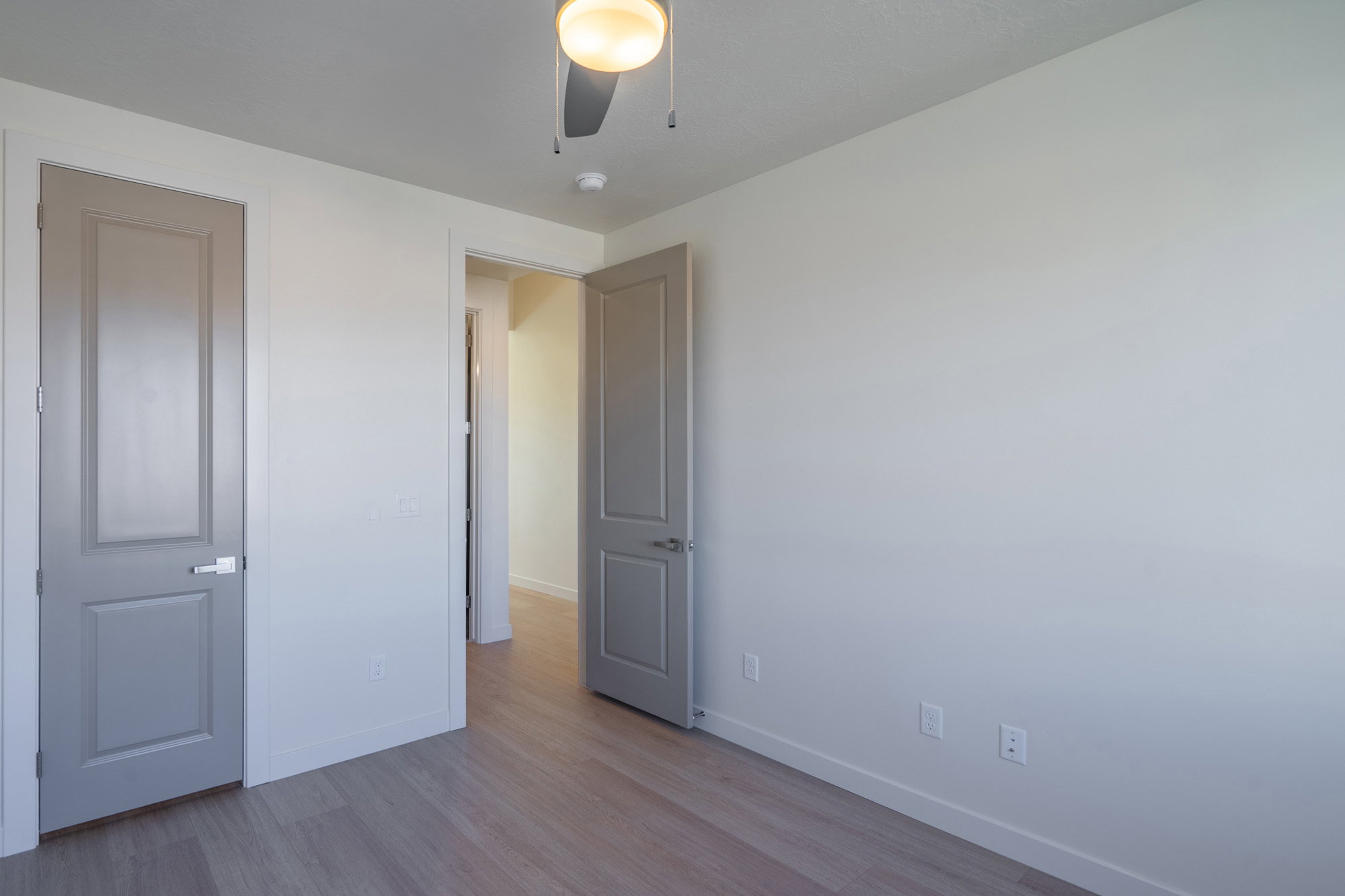 Unfurnished bedroom with light wood-style flooring and ceiling fan