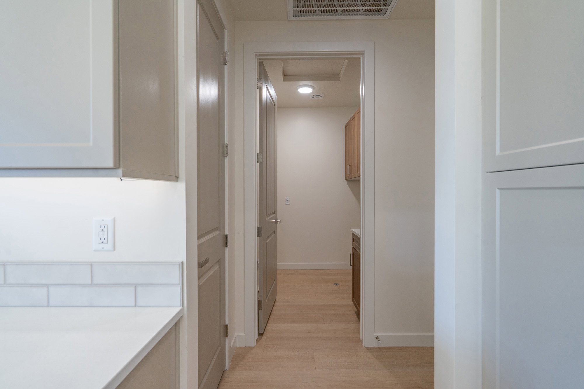 Corridor with baseboards and light wood-style floors