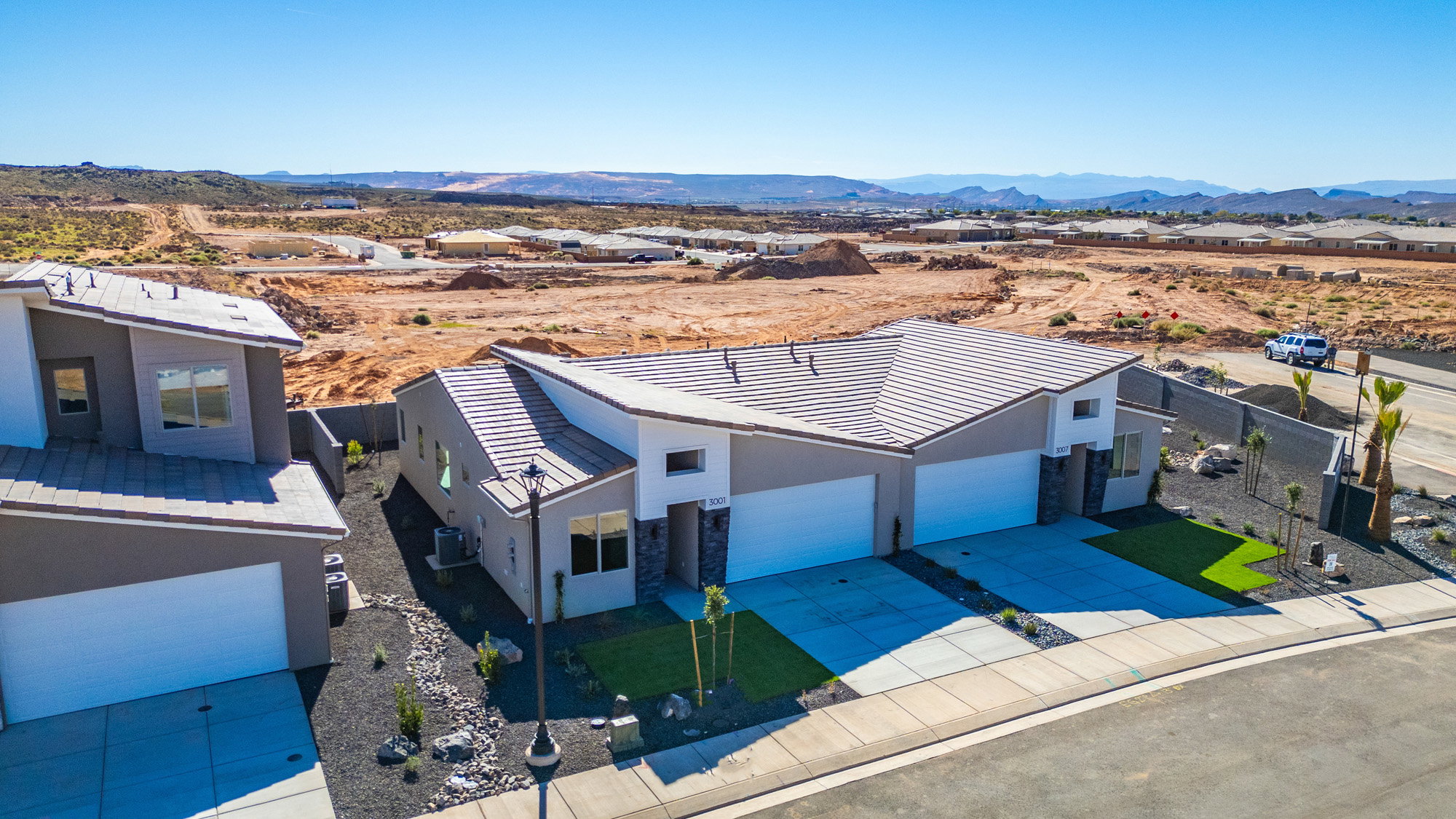 Aerial perspective of suburban area featuring a mountainous background