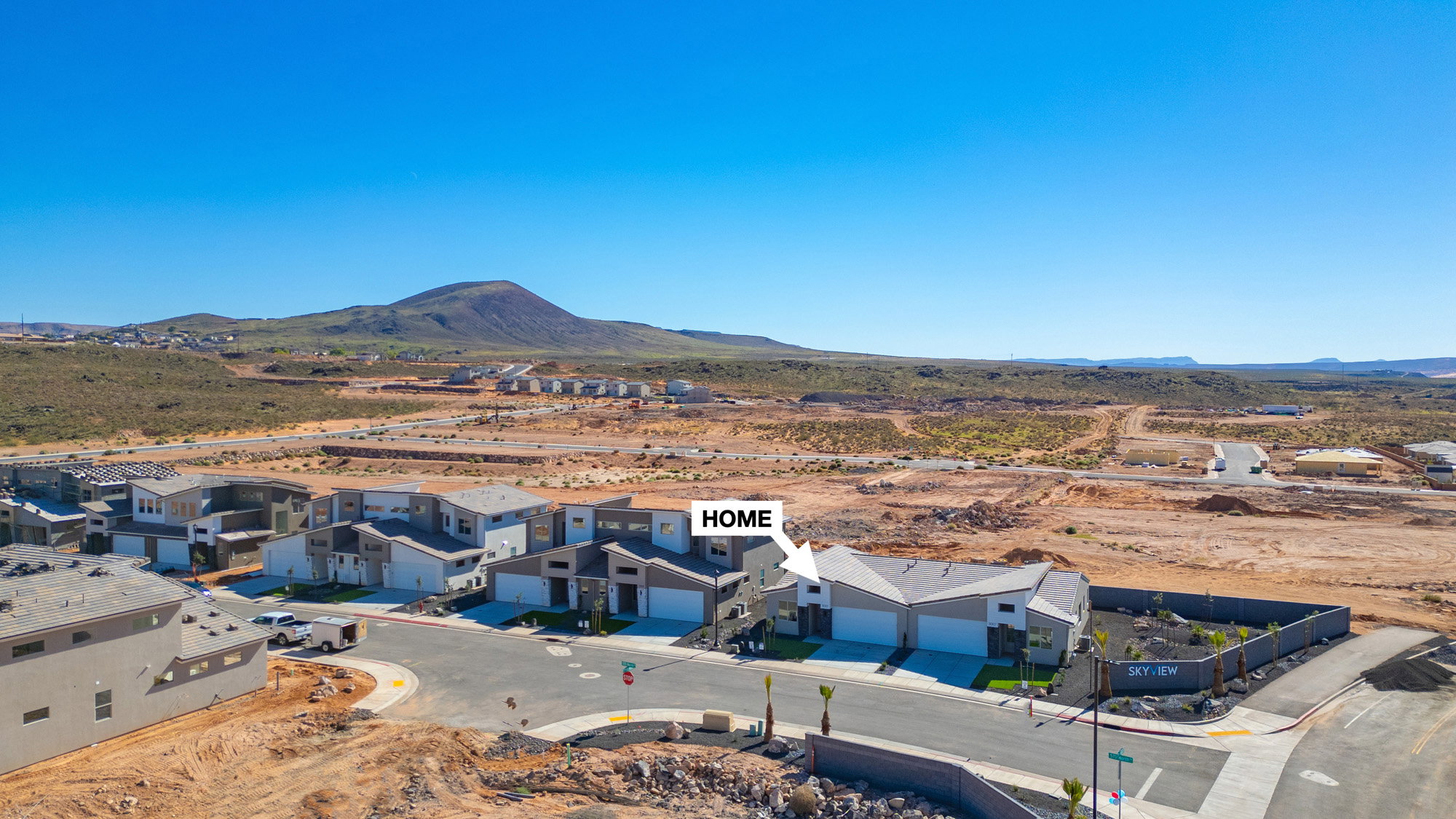 Aerial view of residential area featuring a mountainous background