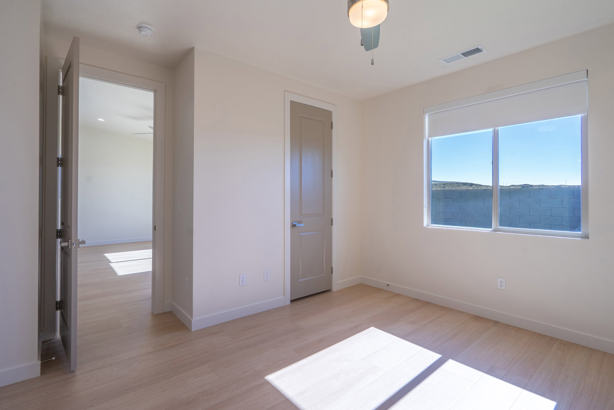 Unfurnished bedroom with light wood-style floors and a ceiling fan