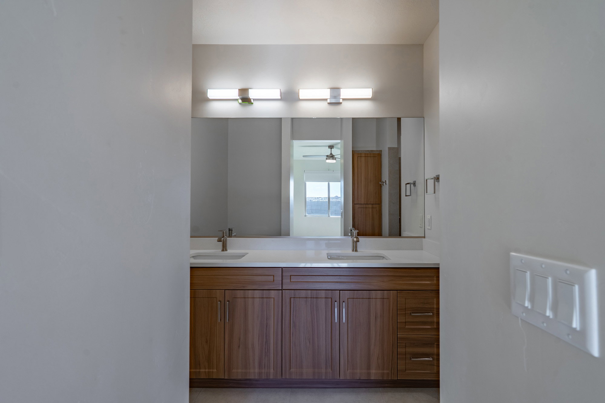 Bathroom featuring double vanity and ceiling fan