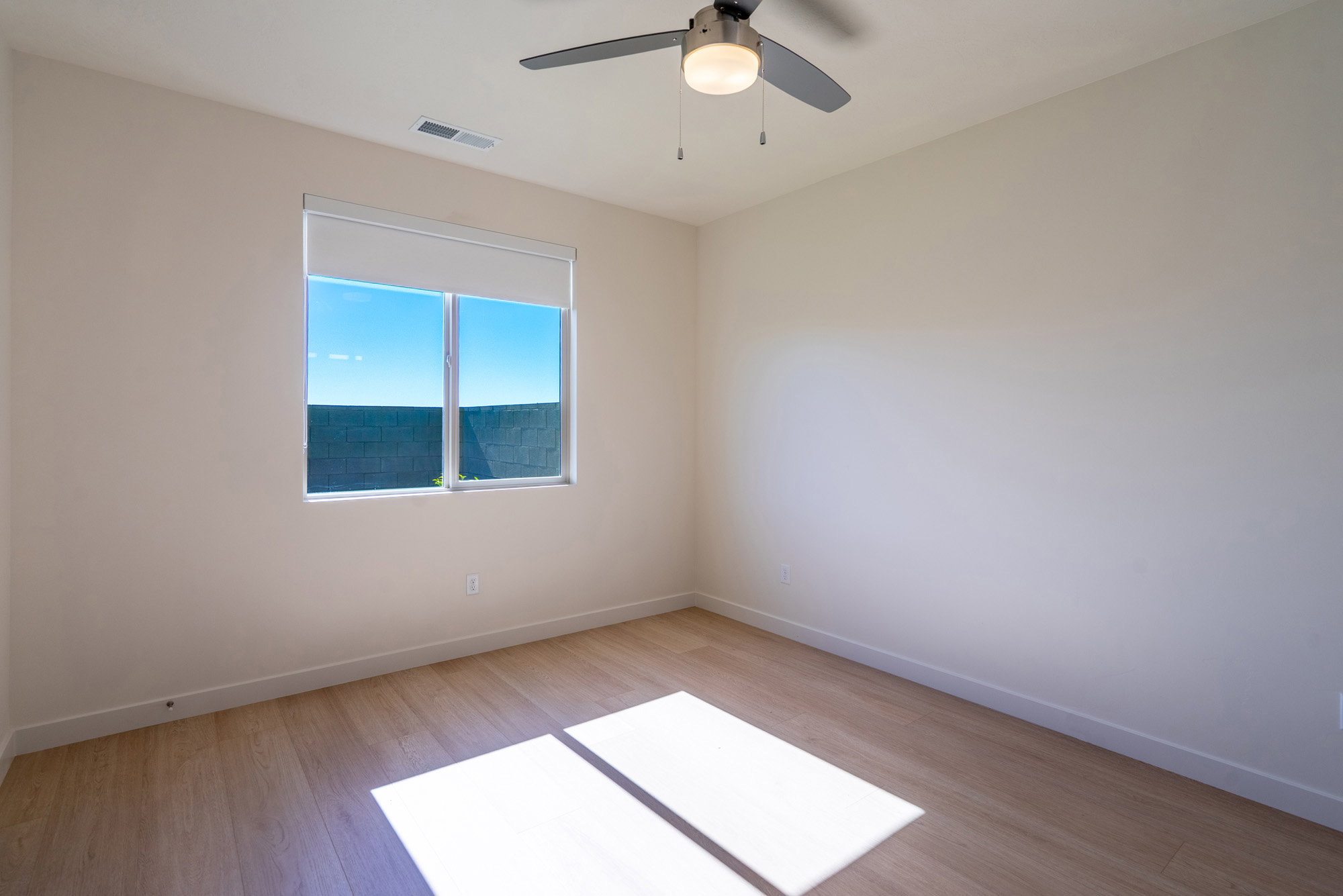 Spare room with light wood-type flooring and a ceiling fan