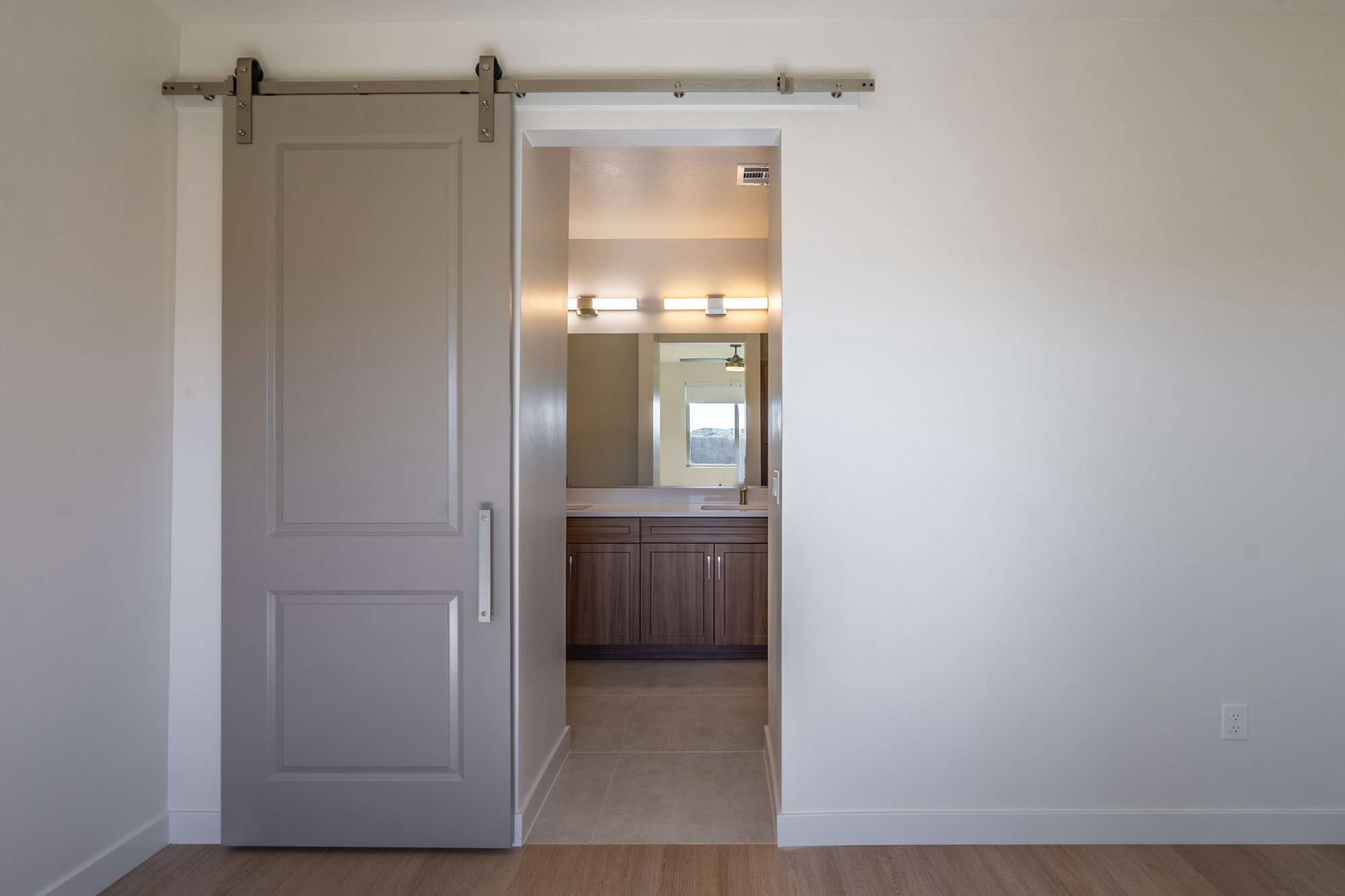 Hallway featuring a barn door and light wood-style floors